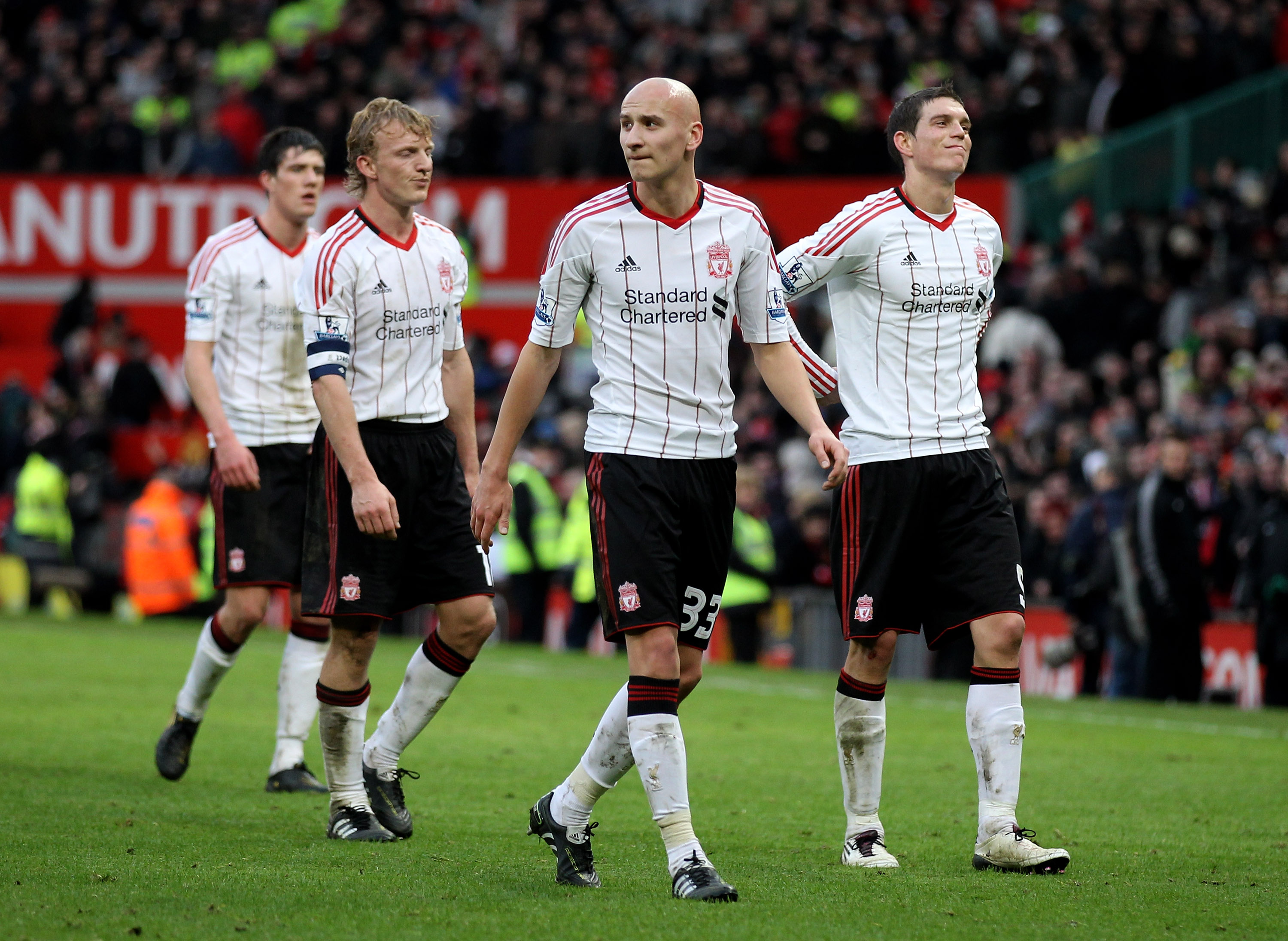 MANCHESTER, ENGLAND - JANUARY 09:   Jonjo Shelvey of Liverpool heads for the dressing room with team mates Martin Kelly (L), Dirk Kuyt and Daniel Agger (R) at the end of the FA Cup sponsored by E.ON 3rd round match between Manchester United and Liverpool