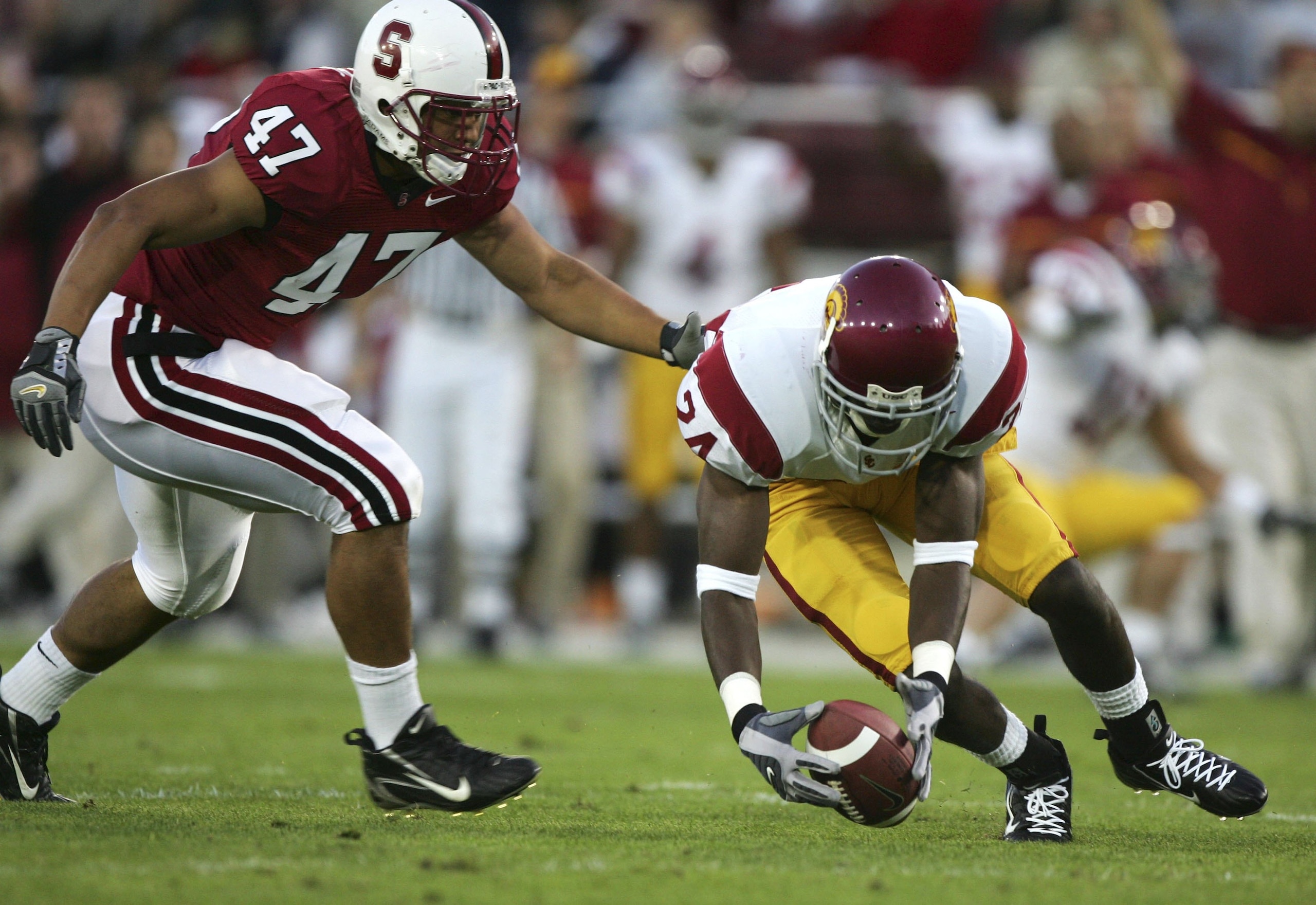 PALO ALTO, CA - NOVEMBER 4: Shareece Wright #24of the USC Trojans picks up a fumble past Jerome Jackson #47 of the Stanford Cardinal during a game on November 4, 2006 at Stanford Stadium in Palo Alto, California.  (Photo by Jed Jacobsohn/Getty Images)