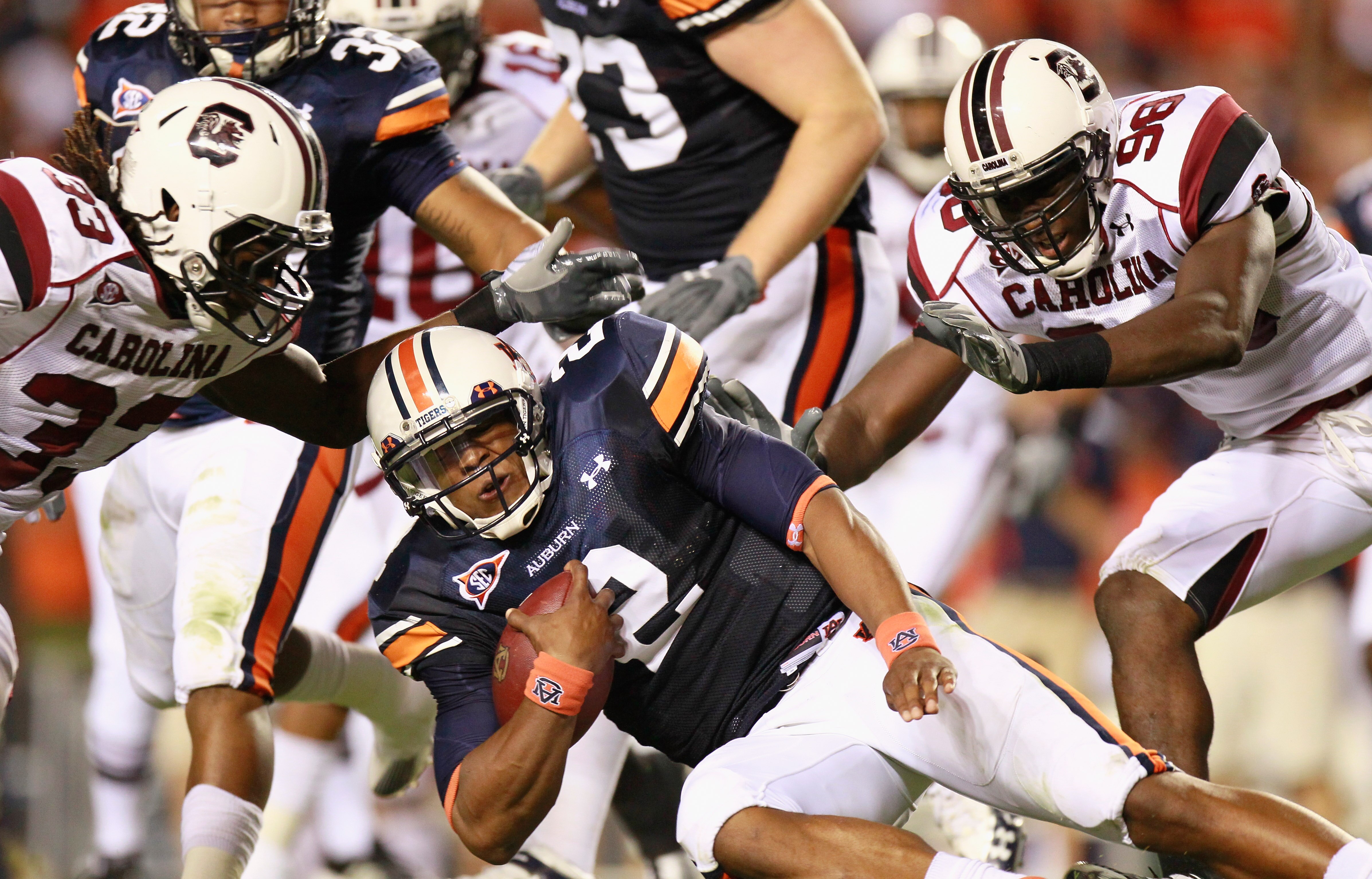 AUBURN, AL - SEPTEMBER 25:  Quarterback Cameron Newton #2 of the Auburn Tigers dives for more yardage against Damario Jeffery #33 and Devin Taylor #98 of the South Carolina Gamecocks at Jordan-Hare Stadium on September 25, 2010 in Auburn, Alabama.  (Photo
