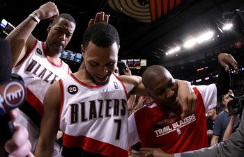 PORTLAND, OR - APRIL 23:  Brandon Roy #7 of the Portland Trail Blazers celebrates with teammates Marcus Camby #23 and Armon Johnson #1 after overcoming a 23 point deficit to defeat the of the Dallas Mavericks 84-82 in Game Four of the Western Conference Q