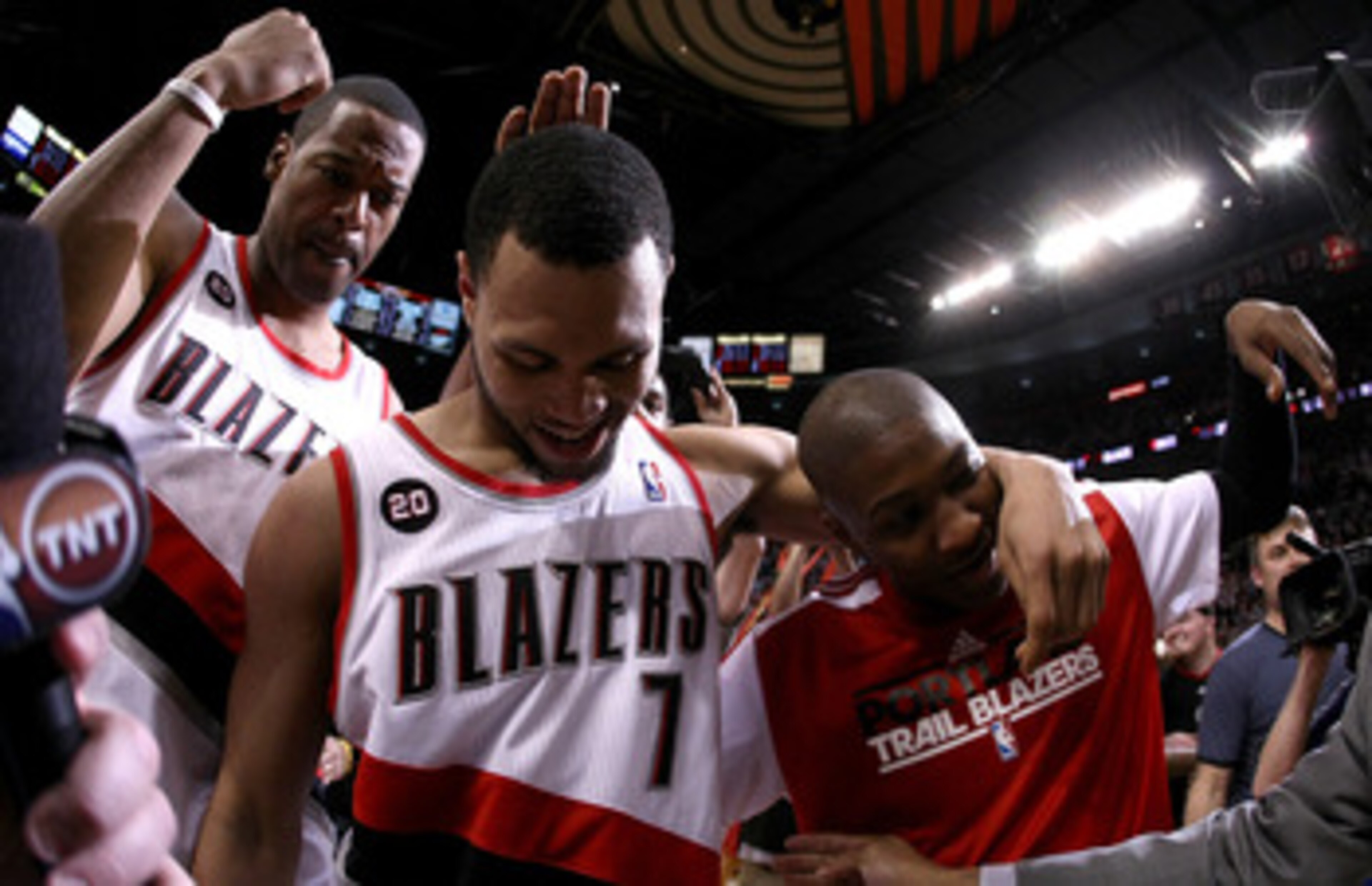 PORTLAND, OR - APRIL 23:  Brandon Roy #7 of the Portland Trail Blazers celebrates with teammates Marcus Camby #23 and Armon Johnson #1 after overcoming a 23 point deficit to defeat the of the Dallas Mavericks 84-82 in Game Four of the Western Conference Q