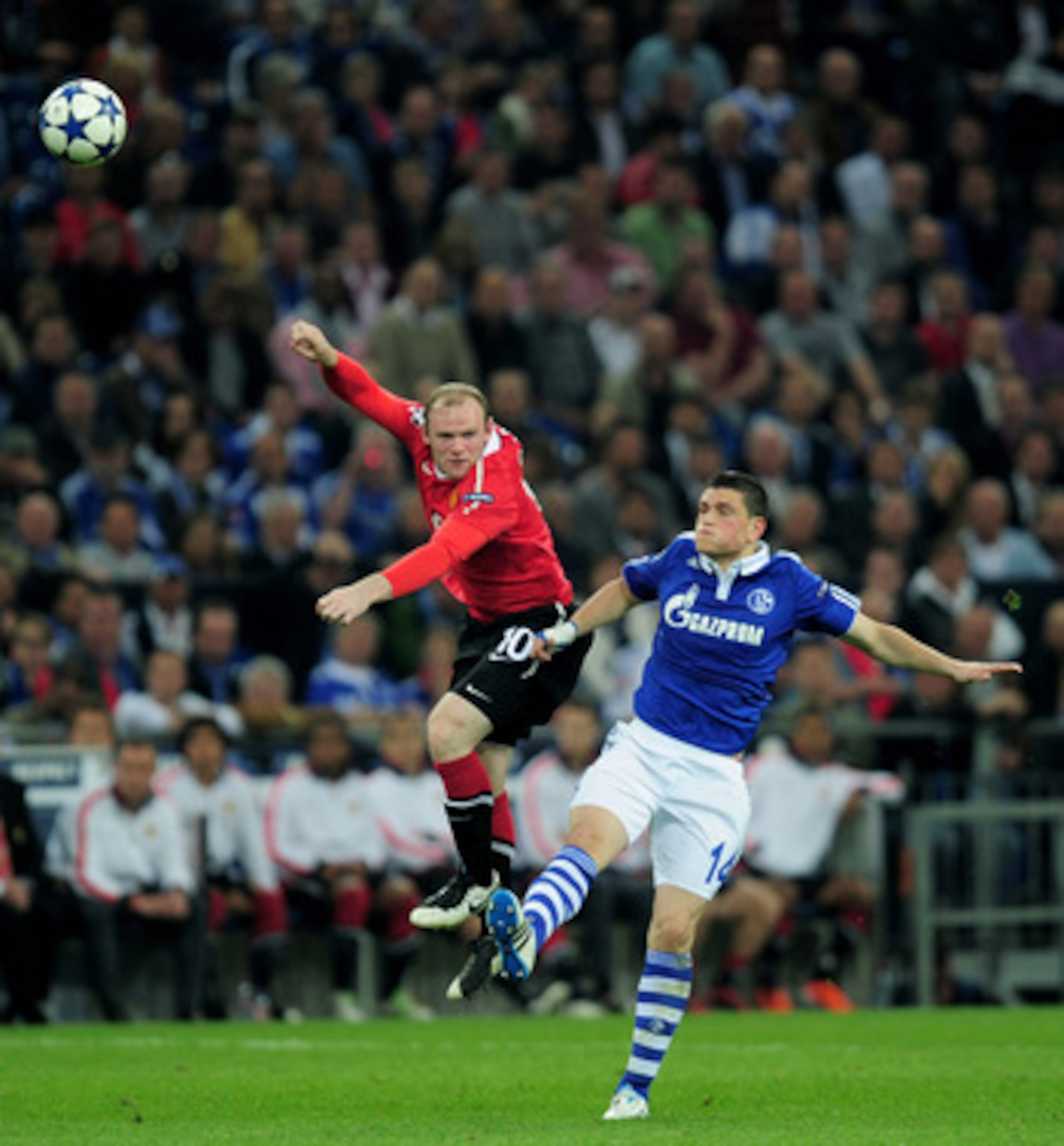 GELSENKIRCHEN, GERMANY - APRIL 26:  Kyriakos Papadopoulos of Schalke competes with Wayne Rooney of Manchester United during the UEFA Champions League Semi Final first leg match between FC Schalke 04 and Manchester United at Veltins Arena on April 26, 2011