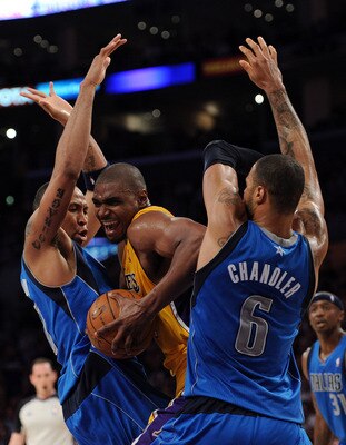 LOS ANGELES, CA - MARCH 31:  Andrew Bynum #17 of the Los Angeles Lakers attempts to split the defense of Shawn Marion #0 and Tyson Chandler #6 of the Dallas Mavericks at Staples Center on March 31, 2011 in Los Angeles, California.  NOTE TO USER: User expr