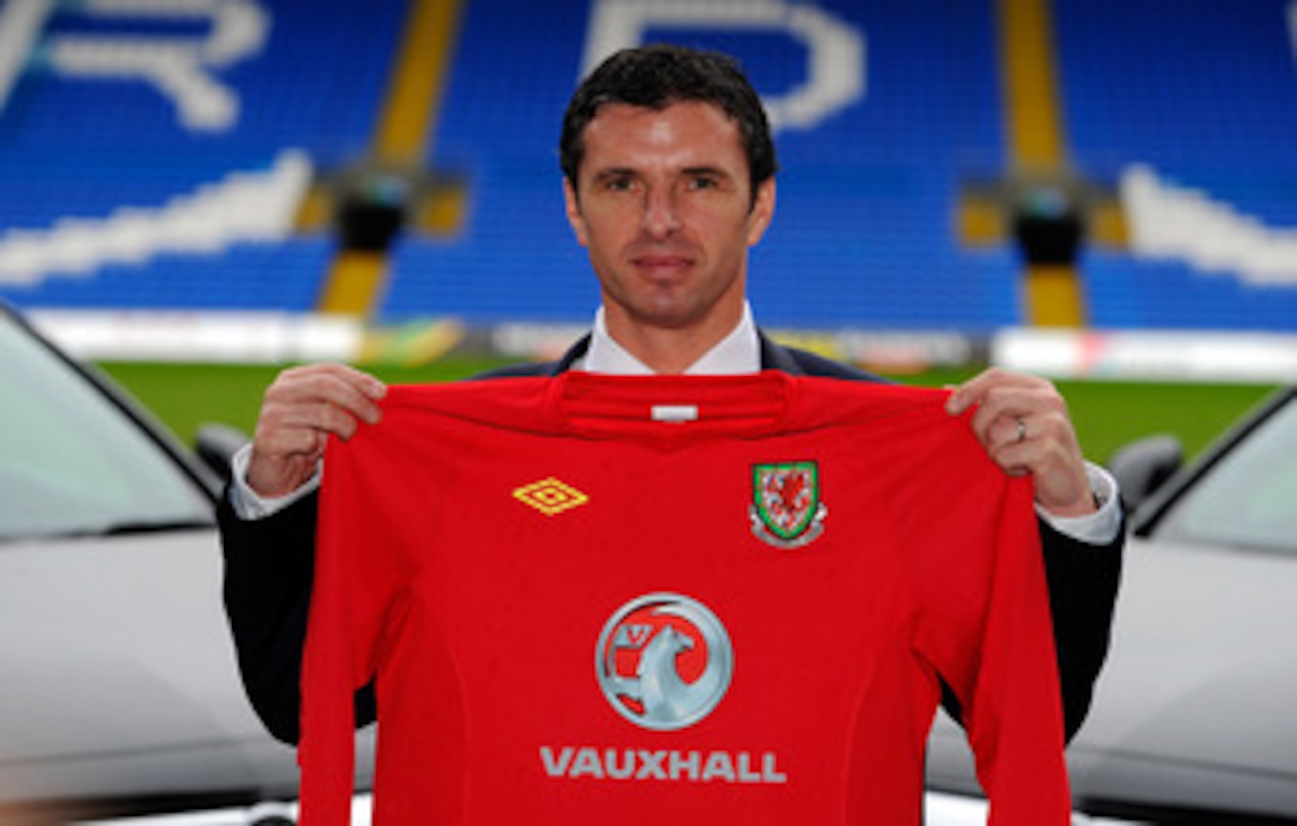 CARDIFF, WALES - JANUARY 12: Wales manager Gary Speed holds up the team shirt at the launch of the announcment of Vauxhall as the new team sponsor at Cardiff City Stadium on January 12, 2011 in Cardiff, Wales. (Photo by Stu Forster/Getty Images) CARDIFF, WALES - JANUARY 12: Wales manager Gary Speed holds up the team shirt at the launch of the announcment of Vauxhall as the new team sponsor at Cardiff City Stadium on January 12, 2011 in Cardiff, Wales. (Photo by Stu Forster/Getty Images)