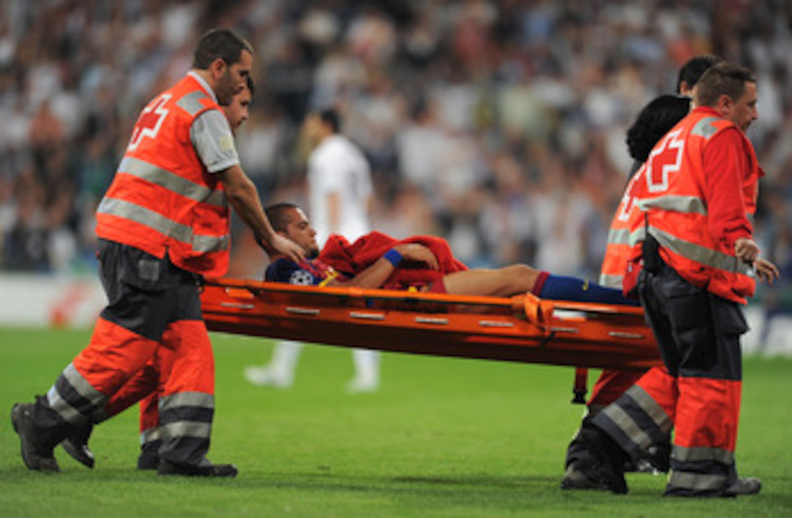 MADRID, SPAIN - APRIL 27: Daniel Alves of Barcelona is stretchered off the pitch after being fouled by Pepe of Real Madrid during the UEFA Champions League Semi Final first leg match between Real Madrid and Barcelona at the Estadio Santiago Bernabeu on A MADRID, SPAIN - APRIL 27: Daniel Alves of Barcelona is stretchered off the pitch after being fouled by Pepe of Real Madrid during the UEFA Champions League Semi Final first leg match between Real Madrid and Barcelona at the Estadio Santiago Bernabeu on A