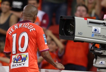 BRISBANE, AUSTRALIA - FEBRUARY 26:  Henrique of the Roar screams down the tv camera as he celebrates scoring the match winning goal during the A-League major semi final match between the Brisbane Roar and the Central Coast Mariners at Suncorp Stadium on F