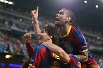 MADRID, SPAIN - APRIL 27:  Lionel Messi of Barcelona celebrates with Dani Alves after scoring his second goal during the UEFA Champions League Semi Final first leg match between Real Madrid and Barcelona at Estadio Santiago Bernabeu on April 27, 2011 in M