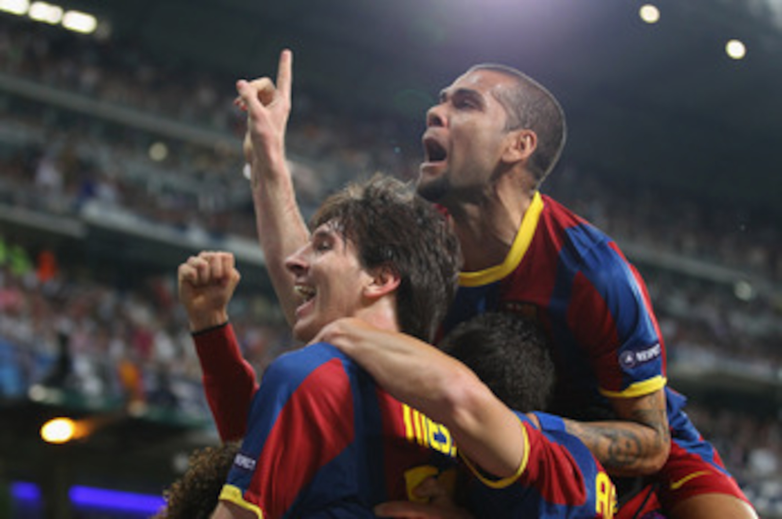 MADRID, SPAIN - APRIL 27: Lionel Messi of Barcelona celebrates with Dani Alves after scoring his second goal during the UEFA Champions League Semi Final first leg match between Real Madrid and Barcelona at Estadio Santiago Bernabeu on April 27, 2011 in M MADRID, SPAIN - APRIL 27: Lionel Messi of Barcelona celebrates with Dani Alves after scoring his second goal during the UEFA Champions League Semi Final first leg match between Real Madrid and Barcelona at Estadio Santiago Bernabeu on April 27, 2011 in M