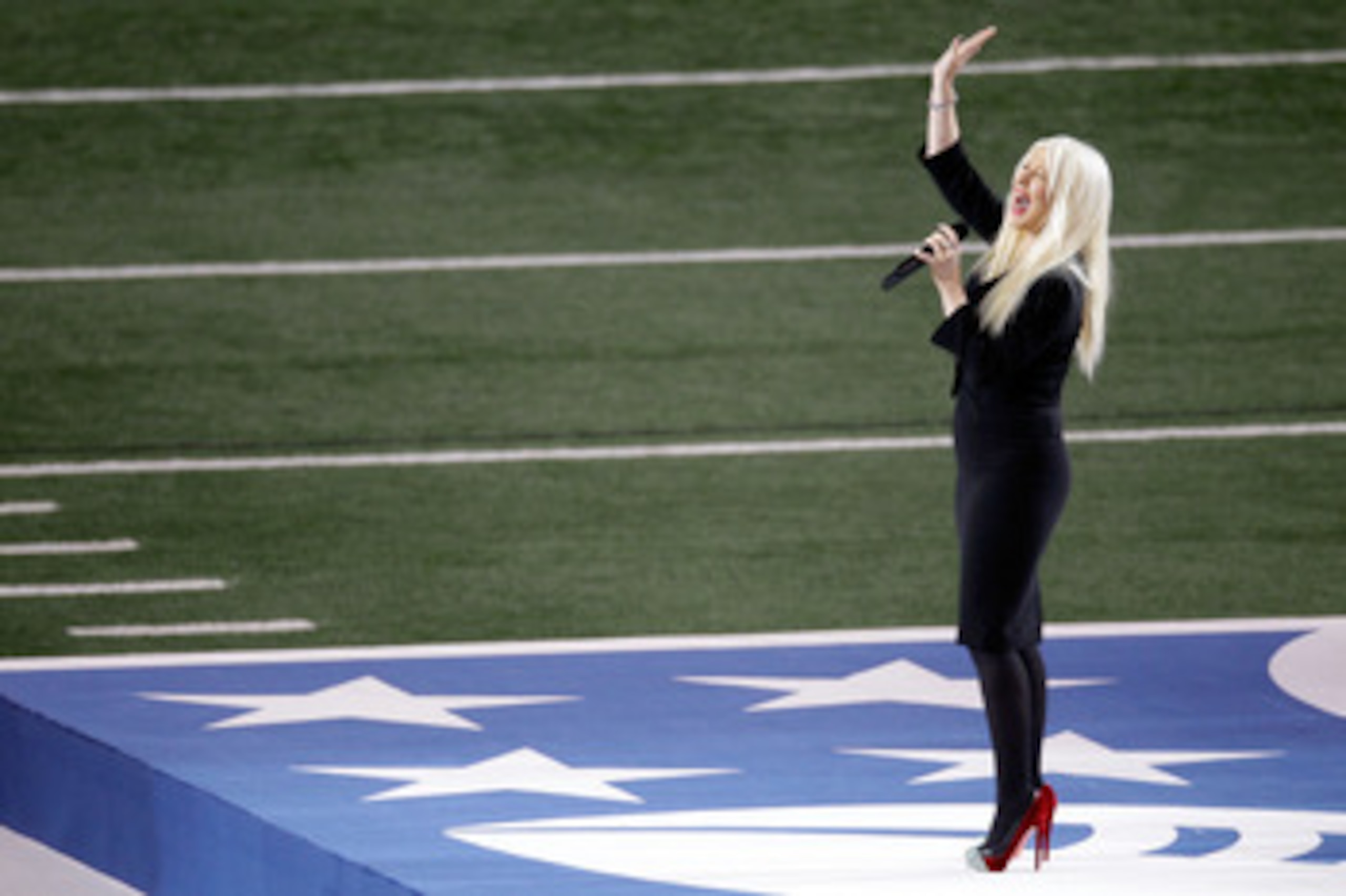ARLINGTON, TX - FEBRUARY 06: Singer Christina Aguilera sings the national anthem during Super Bowl XLV at Cowboys Stadium on February 6, 2011 in Arlington, Texas. (Photo by Rob Carr/Getty Images) ARLINGTON, TX - FEBRUARY 06: Singer Christina Aguilera sings the national anthem during Super Bowl XLV at Cowboys Stadium on February 6, 2011 in Arlington, Texas. (Photo by Rob Carr/Getty Images)