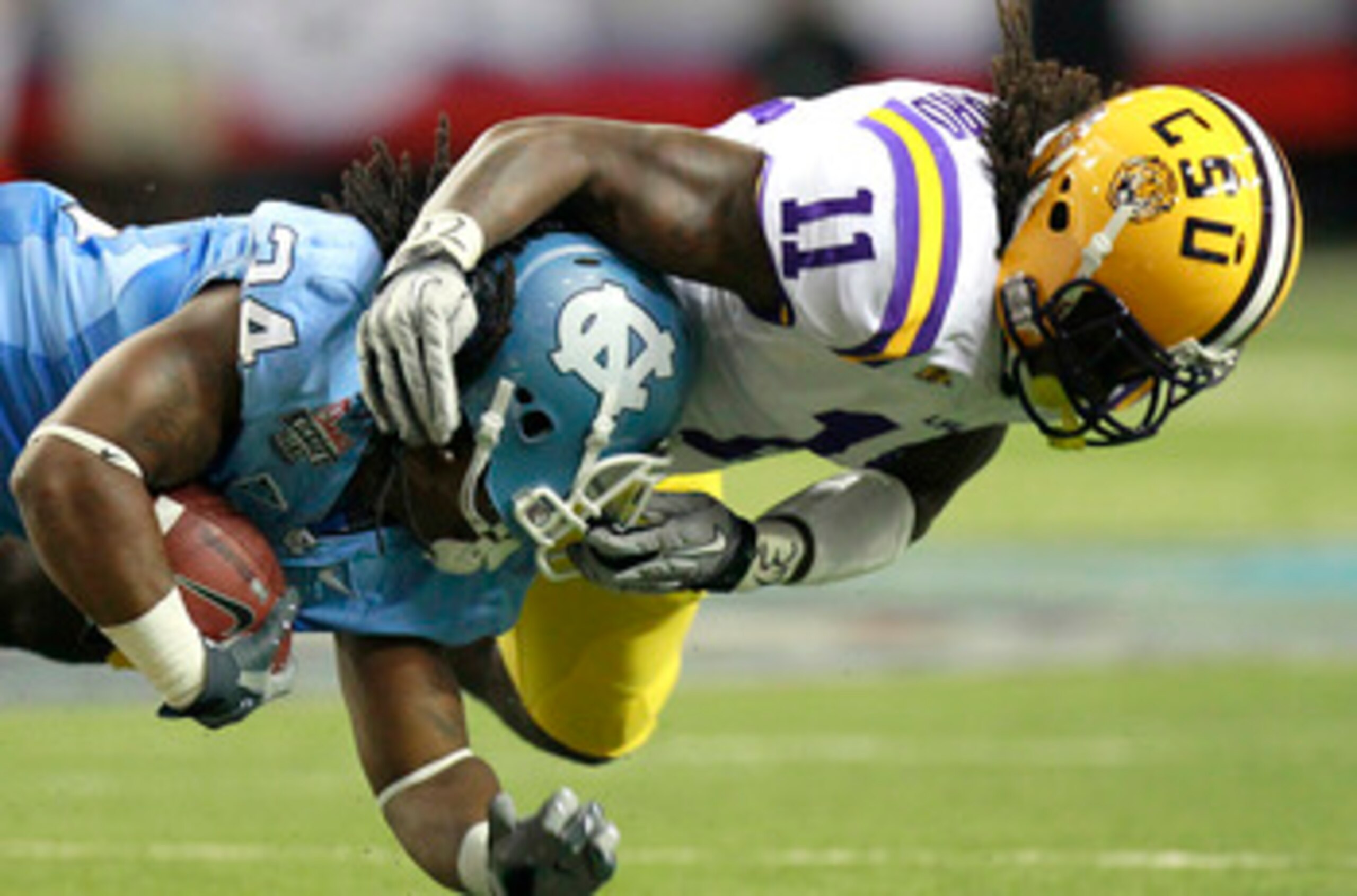 ATLANTA - SEPTEMBER 4: Kelvin Sheppard #11 of the LSU Tigers tackles Johnny White #34 of the North Carolina Tar Heels at the Georgia Dome September 4, 2010 in Atlanta, Georgia.  (Photo by Kevin C. Cox/Getty Images)