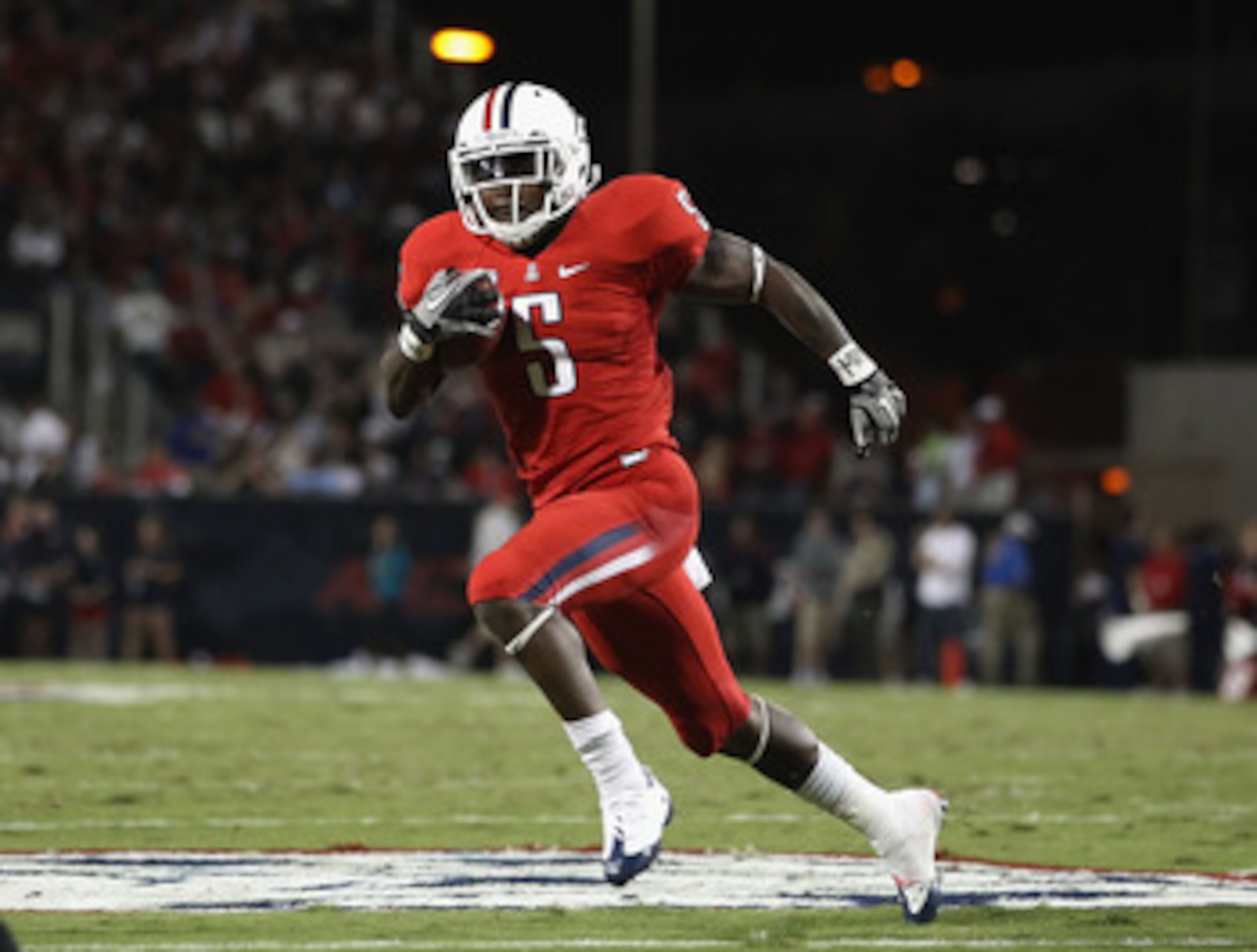 TUCSON, AZ - OCTOBER 23:  Runningback Nic Grigsby #5 of the Arizona Wildcats runs with the ball during the college football game against the Washington Huskies at Arizona Stadium on October 23, 2010 in Tucson, Arizona.   The Wildcats defeated the Huskies 