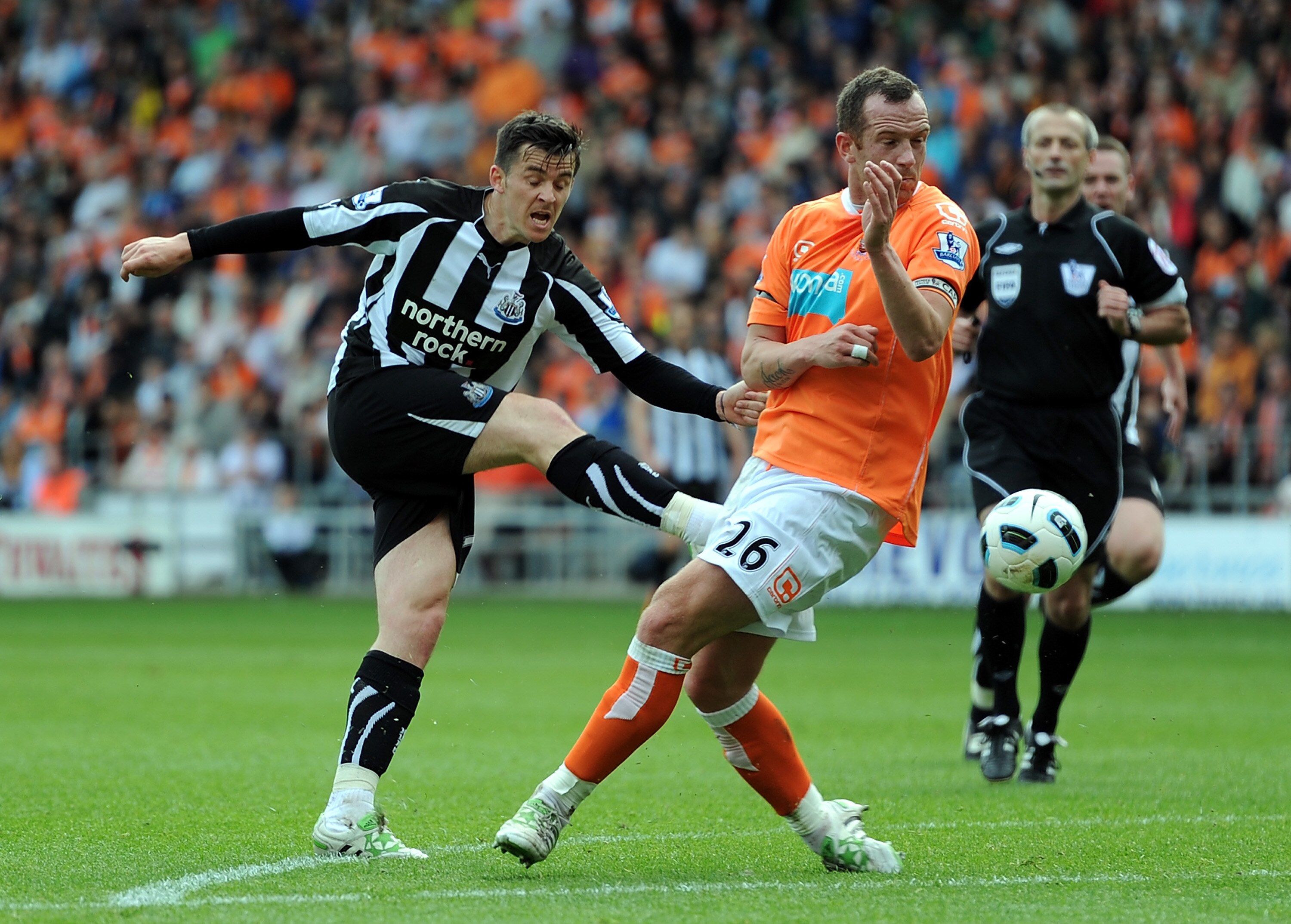 BLACKPOOL, ENGLAND - APRIL 23: Joey Barton of Newcastle United shoots at goal as Charlie Adam of Blackpool blocks during the Barclays Premier League match between Blackpool and Newcastle United at Bloomfield Road on April 23, 2011 in Blackpool, England.