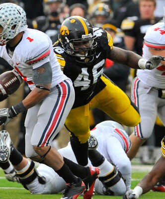 IOWA CITY, IA - NOVEMBER 20:  Tailback Dan Herron #1 of the Ohio State Buckeyes scrambles for yards past defensive end Christian Ballard $46 of the University of Iowa Hawkeyes during the second half of play at Kinnick Stadium on November 20, 2010 in Iowa