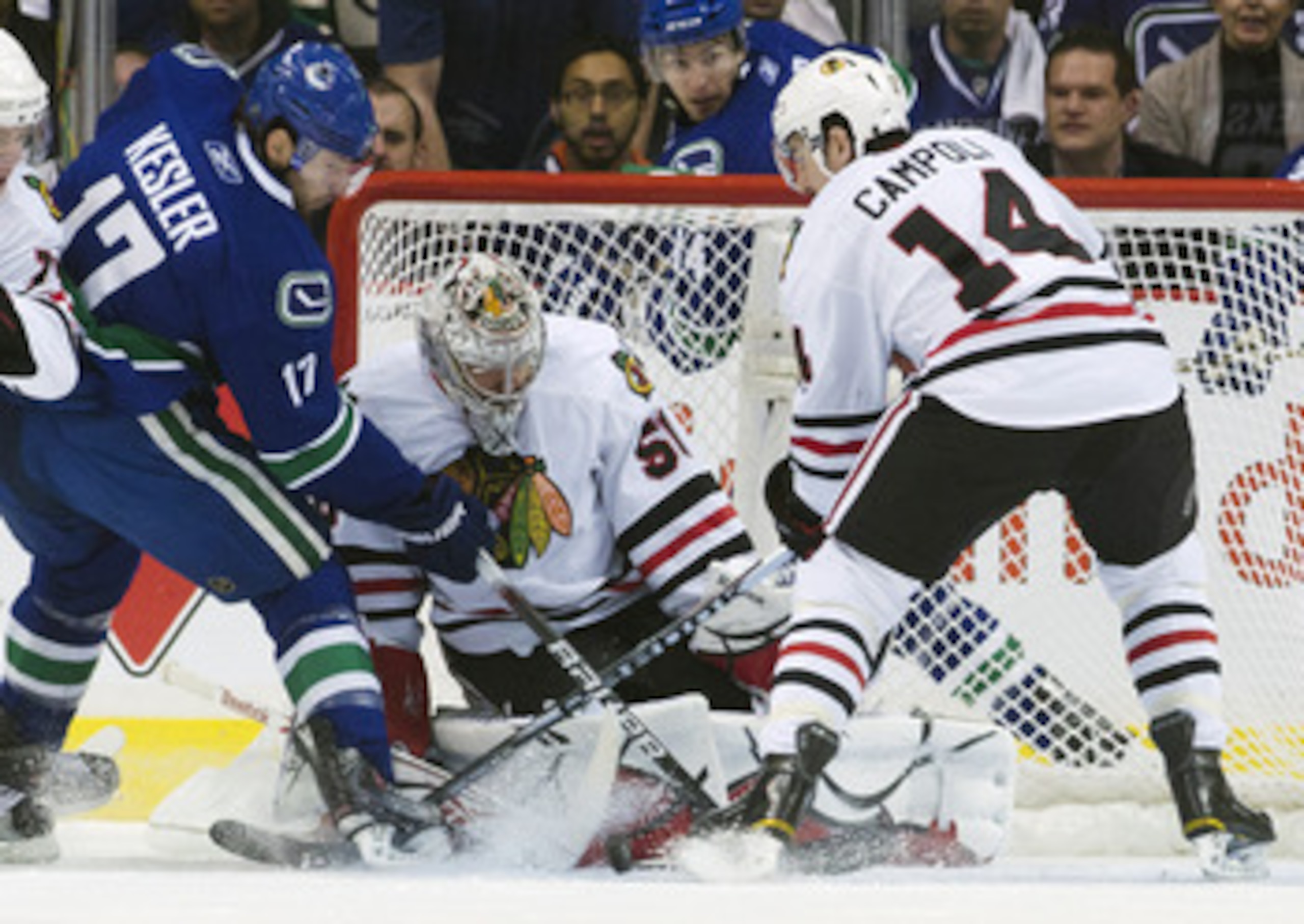 VANCOUVER, CANADA - APRIL 26: Ryan Kesler #17 of the Vancouver Canucks tips the puck towards goalie Corey Crawford #50 of the Chicago Blackhawks while being watched by Chris Campoli #14 of the Chicago Blackhawks during the first period in Game Seven of th