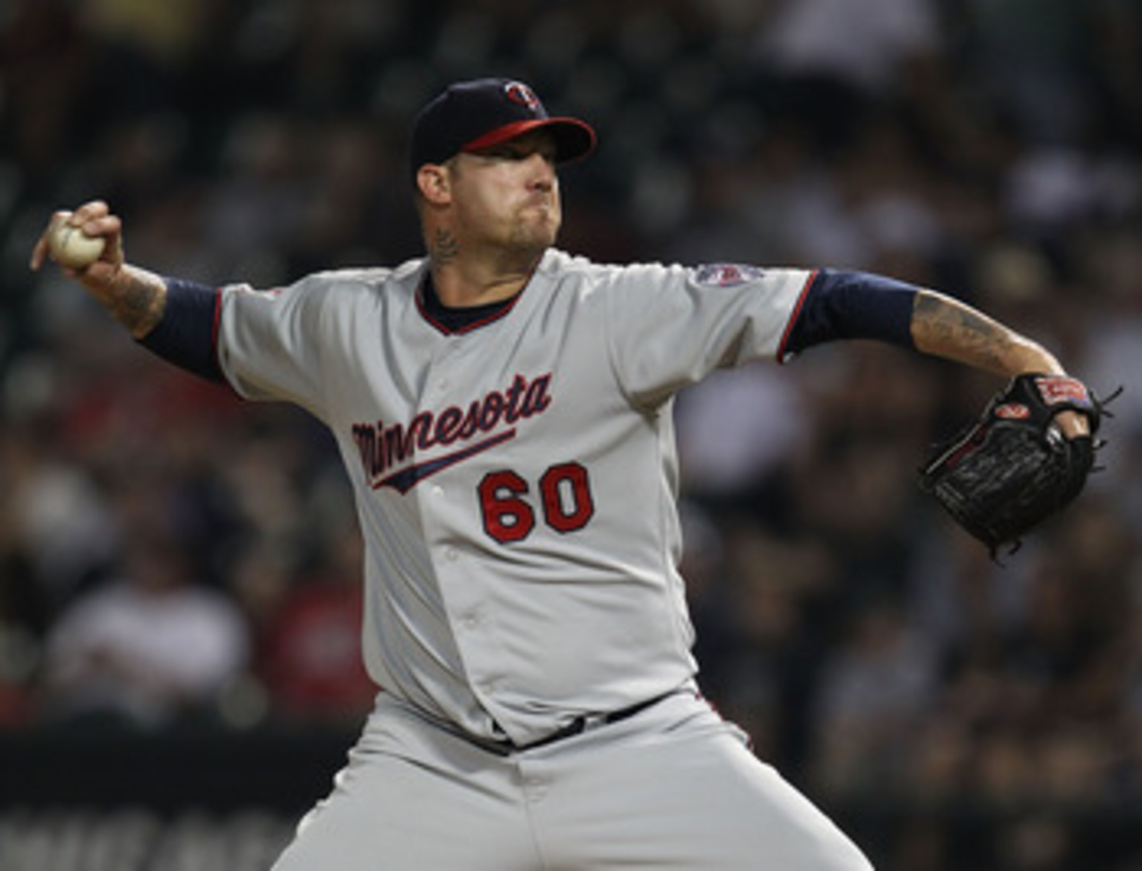 CHICAGO - AUGUST 10: Jon Rauch #60 of the Minnesota Twins pitches in the 9th inning against the Chicago White Sox at U.S. Cellular Field on August 10, 2010 in Chicago, Illinois. The Twins defeated the White Sox 12-6. (Photo by Jonathan Daniel/Getty Images
