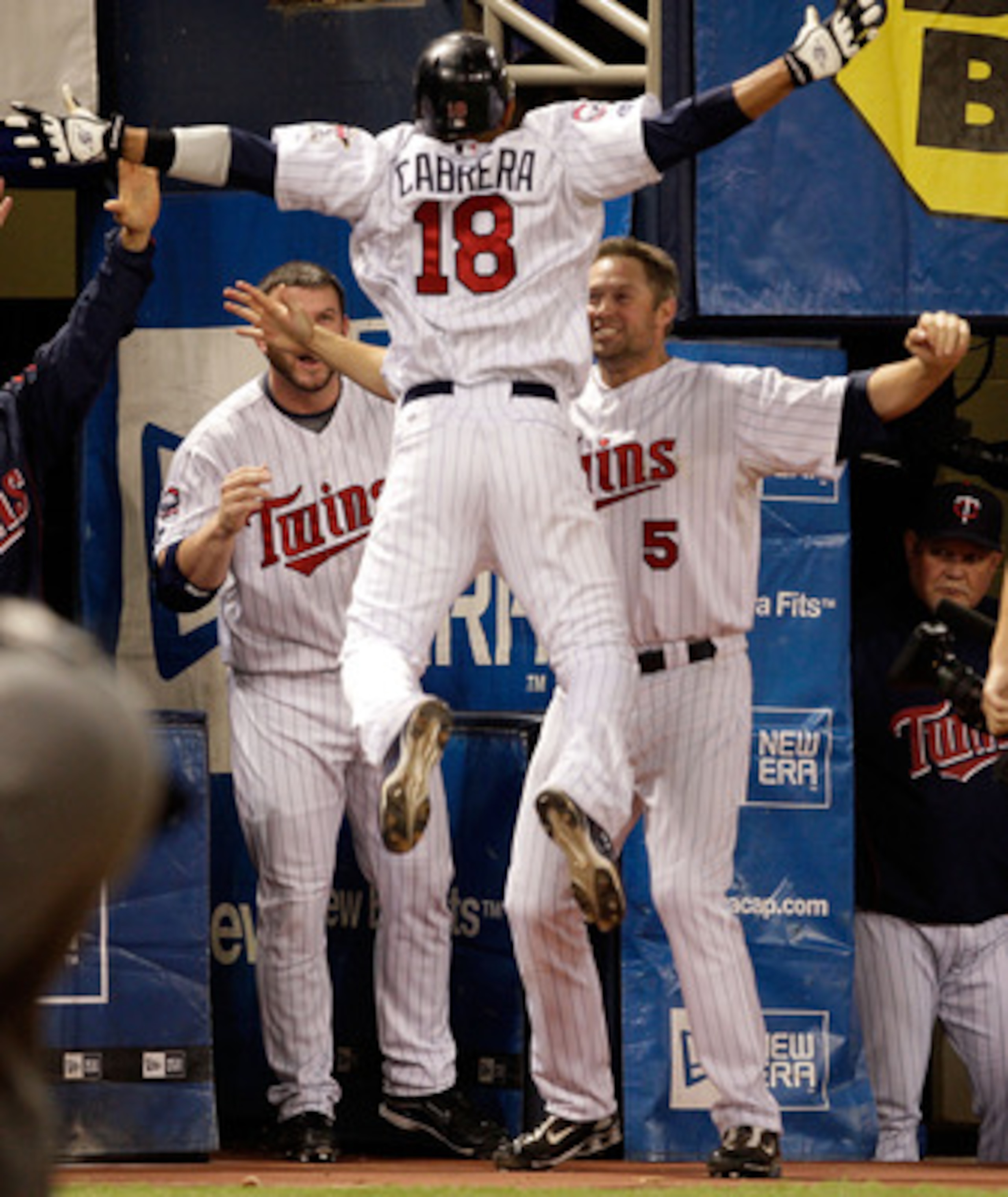 MINNEAPOLIS - OCTOBER 06:  Orlando Cabrera #18 of the Minnesota Twins is congratulated by teammates after hitting a home run against starting pitcher Rick Porcello # 48 of the Detroit Tigers during the 7th inning of the American League Tiebreaker game on