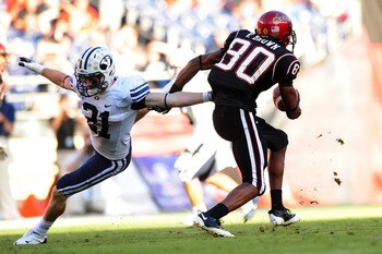 SAN DIEGO - OCTOBER 17:  Tyler Holt #31 of BYU Cougars tries to stop Vincent Brown #80 of San Diego State Aztecs at Qualcomm Stadium on October 17, 2009 in San Diego, California. BYU Cougars defeated the Aztecs 38-28  (Photo by Jacob de Golish/Getty Image