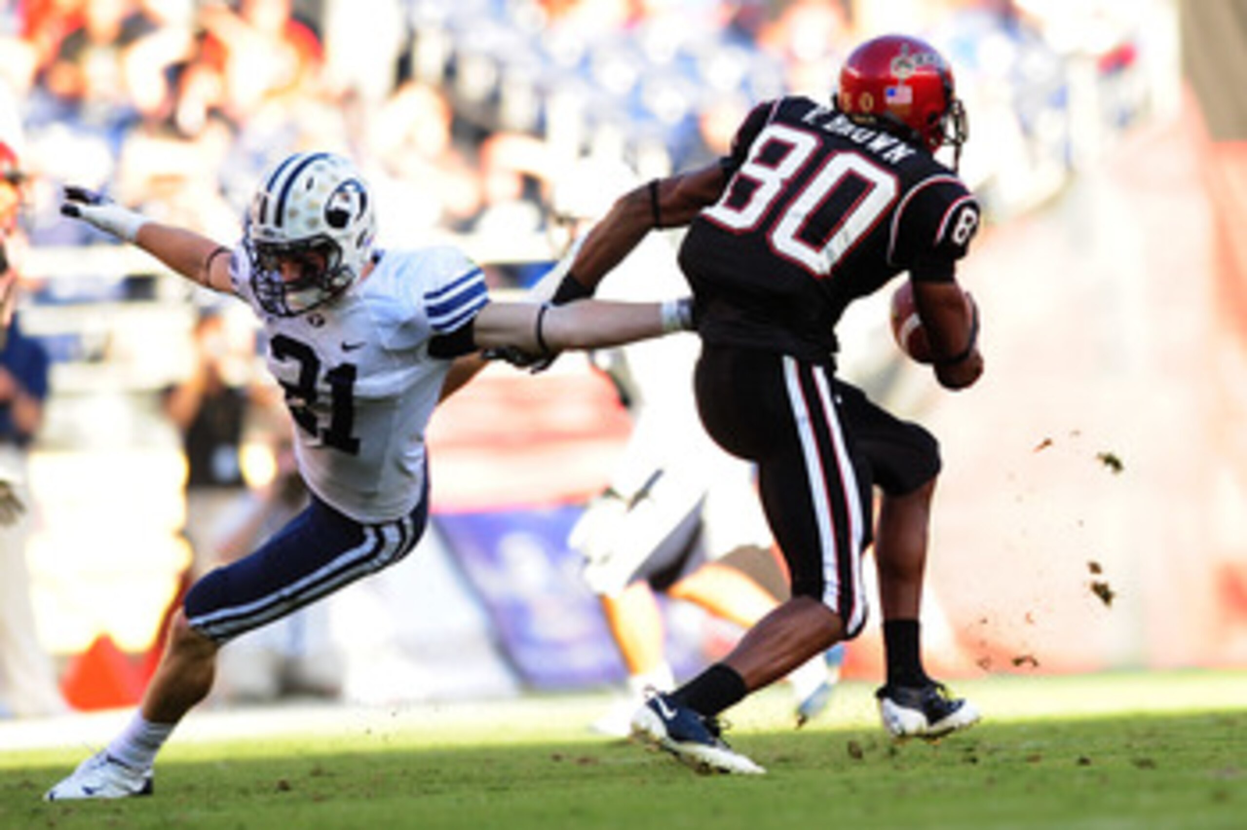 SAN DIEGO - OCTOBER 17: Tyler Holt #31 of BYU Cougars tries to stop Vincent Brown #80 of San Diego State Aztecs at Qualcomm Stadium on October 17, 2009 in San Diego, California. BYU Cougars defeated the Aztecs 38-28 (Photo by Jacob de Golish/Getty Image SAN DIEGO - OCTOBER 17: Tyler Holt #31 of BYU Cougars tries to stop Vincent Brown #80 of San Diego State Aztecs at Qualcomm Stadium on October 17, 2009 in San Diego, California. BYU Cougars defeated the Aztecs 38-28 (Photo by Jacob de Golish/Getty Image