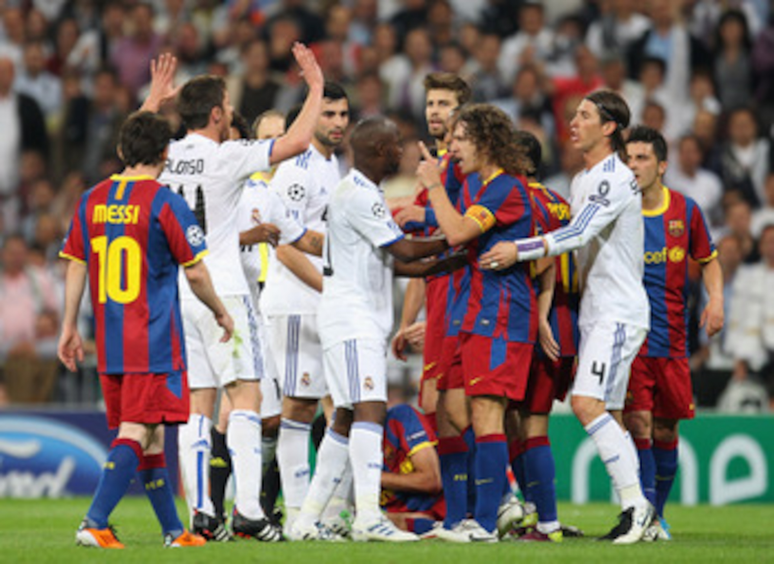 MADRID, SPAIN - APRIL 27:  Lassana Diarra of Real Madrid and Carles Puyol of Barcelona clash during the UEFA Champions League Semi Final first leg match between Real Madrid and Barcelona at Estadio Santiago Bernabeu on April 27, 2011 in Madrid, Spain.  (P