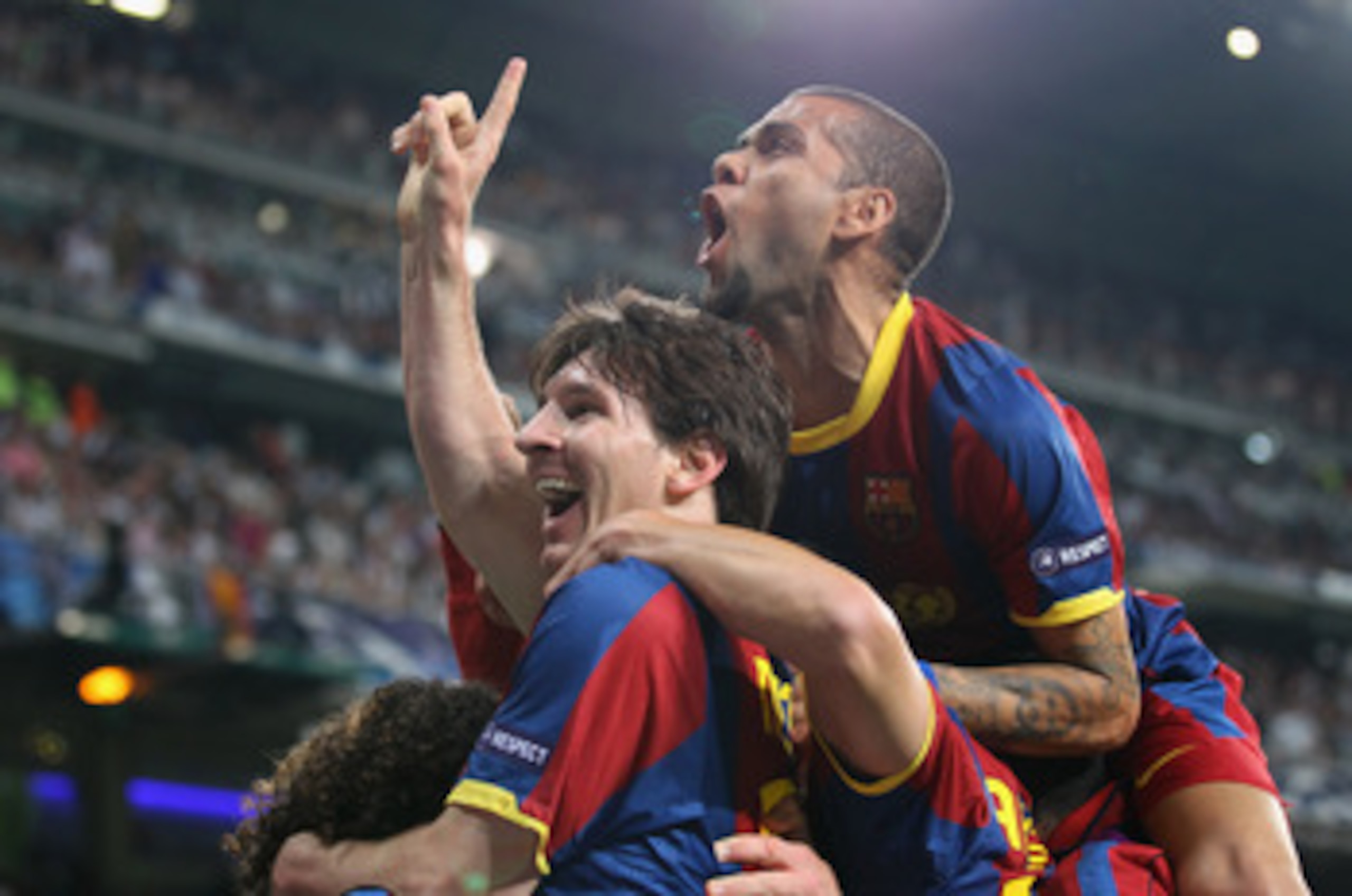 MADRID, SPAIN - APRIL 27:  Lionel Messi of Barcelona celebrates with Dani Alves after scoring his second goal during the UEFA Champions League Semi Final first leg match between Real Madrid and Barcelona at Estadio Santiago Bernabeu on April 27, 2011 in M