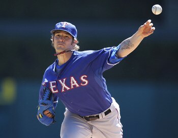 DETROIT, MI - APRIL 12:  C.J. Wilson #36 of thde Texas Rangers thows a warm up pitch while playing the Detroit Tigers at Comerica Park on April 12, 2011 in Detroit, Michigan.  (Photo by Gregory Shamus/Getty Images)