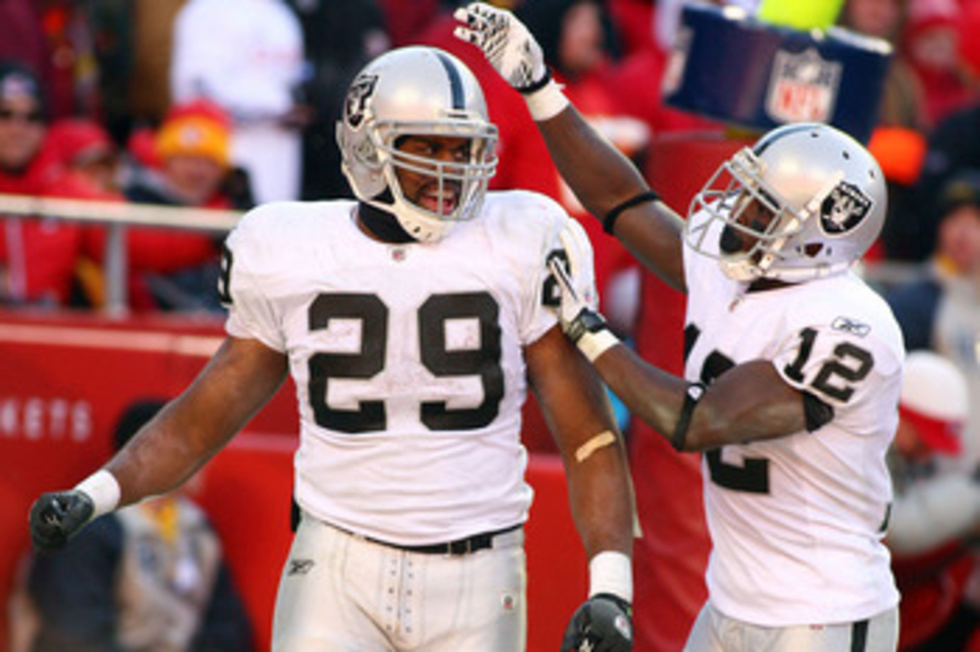KANSAS CITY, MO - JANUARY 02:  Running back Michael Bush #29 of the Oakland Raiders is congratulated by wide receiver Jacoby Ford #12 after scoring a touchdown in a game against the Kansas City Chiefs at Arrowhead Stadium on January 2, 2011 in Kansas City