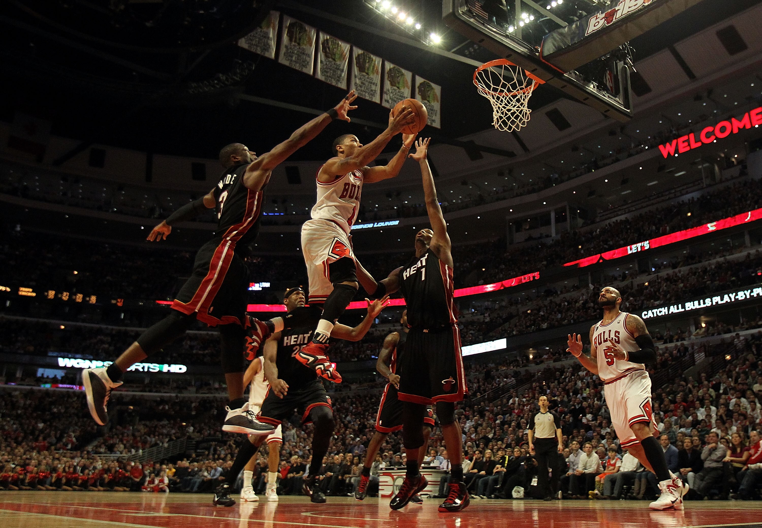 CHICAGO, IL - FEBRUARY 24: Derrick Rose #1 of the Chicago Bulls puts up a shot between Dwyane Wade #3 and Chris Bosh #1 of the Miami Heat at the United Center on February 24, 2011 in Chicago, Illinois. The Bulls defeated the Heat 93-89. NOTE TO USER: User CHICAGO, IL - FEBRUARY 24: Derrick Rose #1 of the Chicago Bulls puts up a shot between Dwyane Wade #3 and Chris Bosh #1 of the Miami Heat at the United Center on February 24, 2011 in Chicago, Illinois. The Bulls defeated the Heat 93-89. NOTE TO USER: User