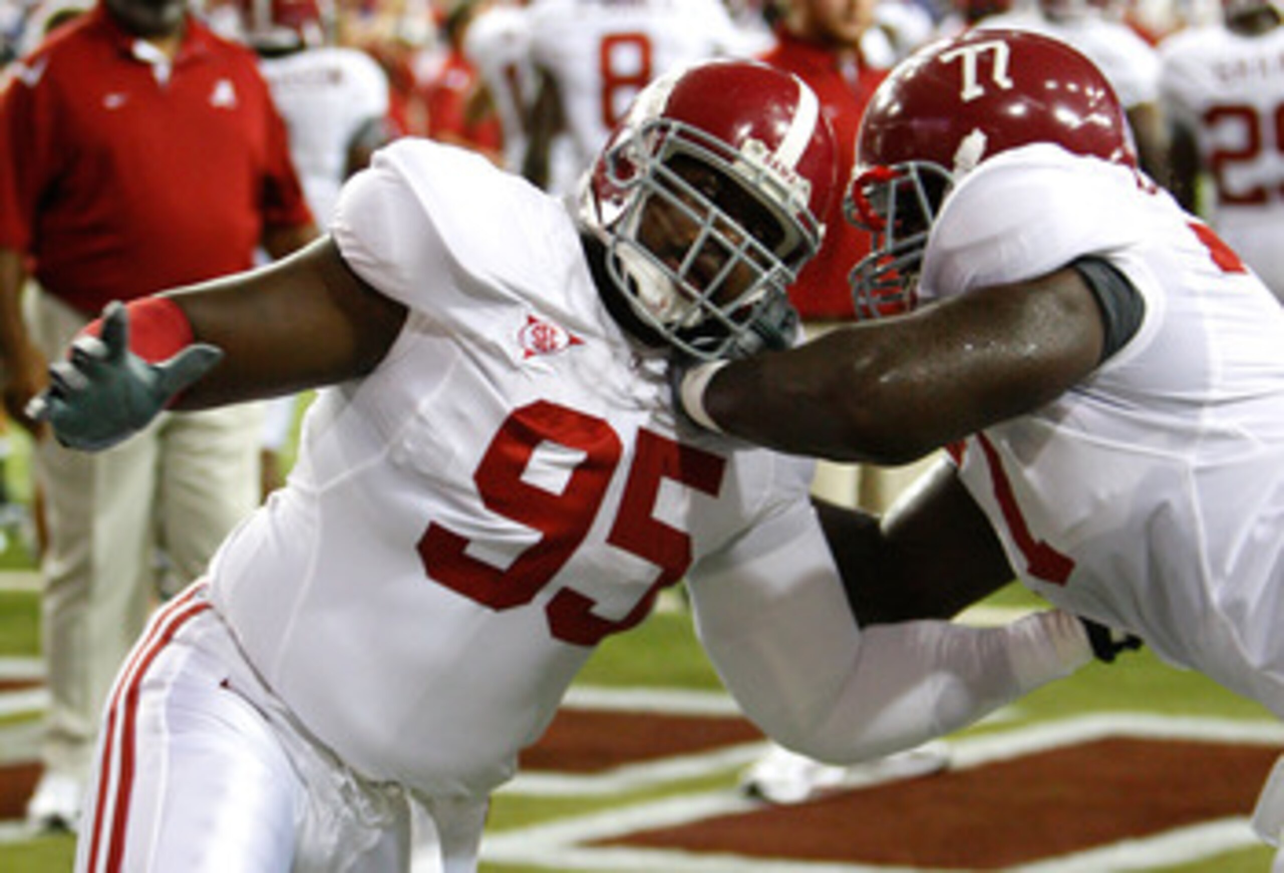 ATLANTA - SEPTEMBER 05:  Defensive lineman Brandon Deaderick #95 of the Alabama Crimson Tide warms up with James Carpenter #77 before facing the Virginia Tech Hokies during the Chick-fil-A Kickoff Game at Georgia Dome on September 5, 2009 in Atlanta, Geor