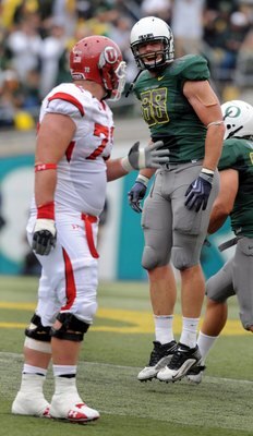 EUGENE, OR - SEPTEMBER 19: Brandon Bair #88 of the Oregon Ducks celebrates after the Ducks recovered a fumble as Caleb Schlauderaff #72 of the Utah Utes walks to the sidelines during the second quarter at Autzen Stadium on September 19, 2009 in Eugene, Or