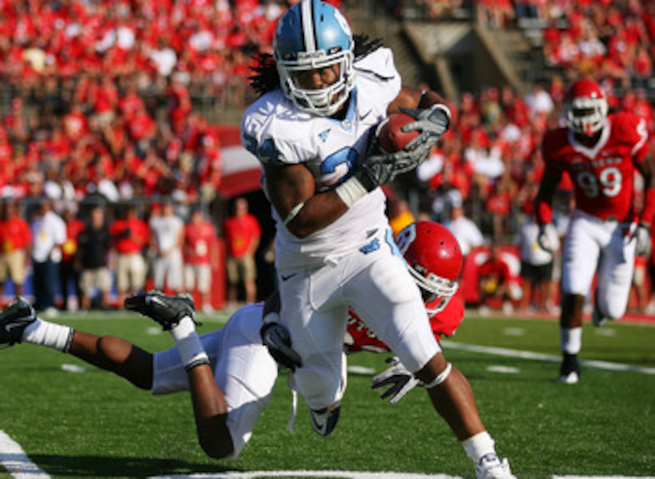 NEW BRUNSWICK, NJ - SEPTEMBER 25: Brandon Bing #23 of the Rutgers Scarlet Knights is unable to tackle Johnny White #34 of the North Carolina Tar Heels during the second quarter at Rutgers Stadium on September 25, 2010 in New Brunswick, New Jersey.  (Photo