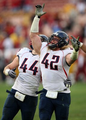 LOS ANGELES - DECEMBER 5:  Defensive ends Brooks Reed #42 and Ricky Elmore #44 of the Arizona Wildcats celebrate after stopping the USC Trojans on the final play on December 5, 2009 at the Los Angeles Coliseum in Los Angeles, California. Arizona won 21-17