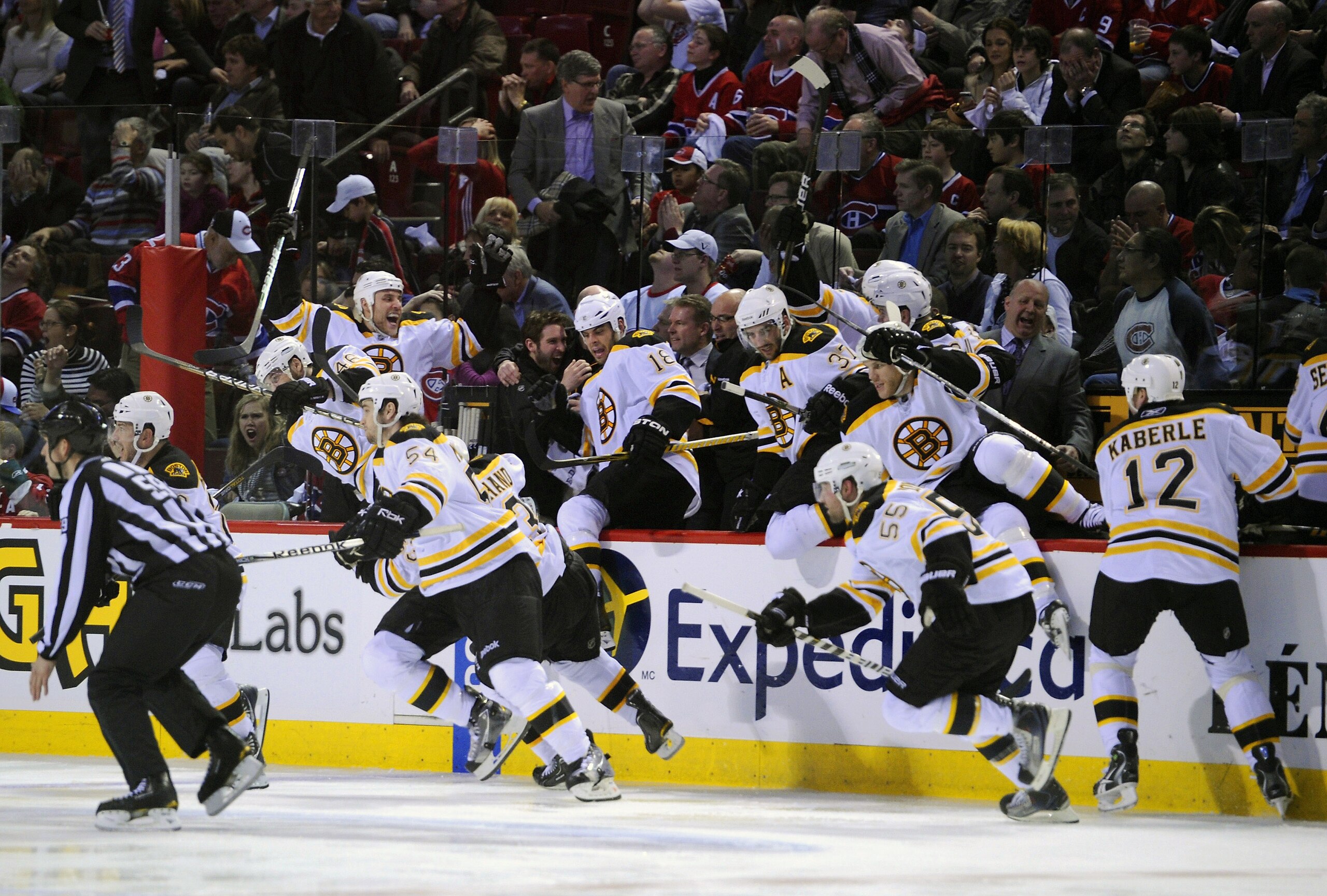 MONTREAL, QC - APRIL 21:  The Boston Bruins bench explodes onto the ice after defeating the Montreal Canadiens in overtime during Game Four of the Eastern Conference Quarterfinals during the 2011 NHL Stanley Cup Playoffs at the Bell Centre on April 21, 20