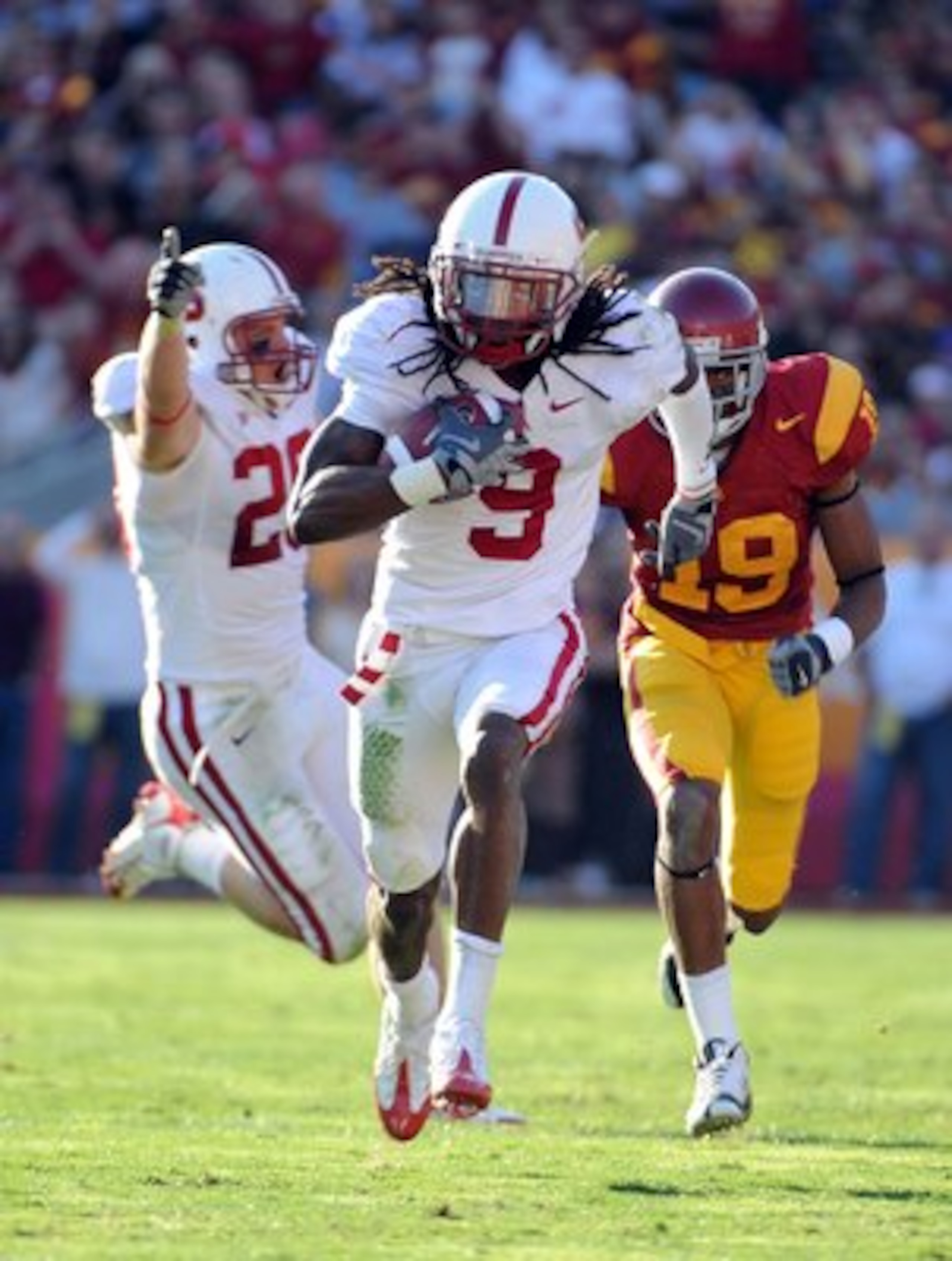 LOS ANGELES, CA - NOVEMBER 14:  Richard Sherman #9 of the Stanford Cardinal scores a touchdown off his interception as he is chased by Drew McAllister #19 of the USC Trojans and  teammate Clinton Snyder #20 celebrates during the second half at the Los Ang