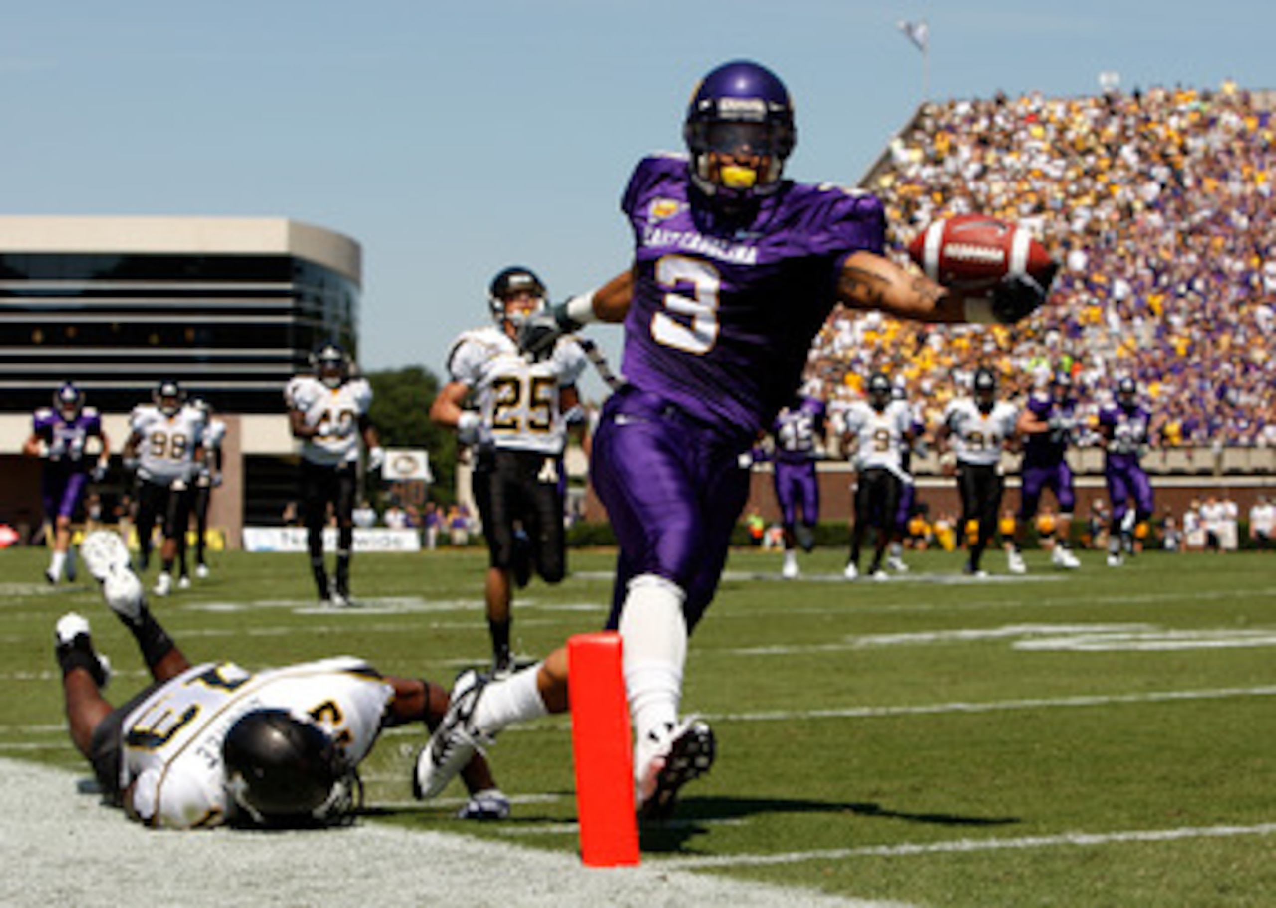 GREENVILLE, NC - SEPTEMBER 05:  Mark LeGree #13 of the Appalachian State Mountaineers dives as Brandon Jackson #3 of the East Carolina Pirates scores a touchdown at Dowdy-Ficklen Stadium on September 5, 2009 in Greenville, North Carolina.  (Photo by Stree