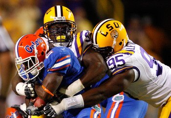 BATON ROUGE, LA - OCTOBER 10: Drake Nevis #92 and Lazarius Levingston #95 of the Louisiana State University Tigers tackle Jeffery Demps #2 of the Florida Gators at Tiger Stadium on October 10, 2009 in Baton Rouge, Louisiana. (Photo by Kevin C. Cox/Getty BATON ROUGE, LA - OCTOBER 10: Drake Nevis #92 and Lazarius Levingston #95 of the Louisiana State University Tigers tackle Jeffery Demps #2 of the Florida Gators at Tiger Stadium on October 10, 2009 in Baton Rouge, Louisiana. (Photo by Kevin C. Cox/Getty