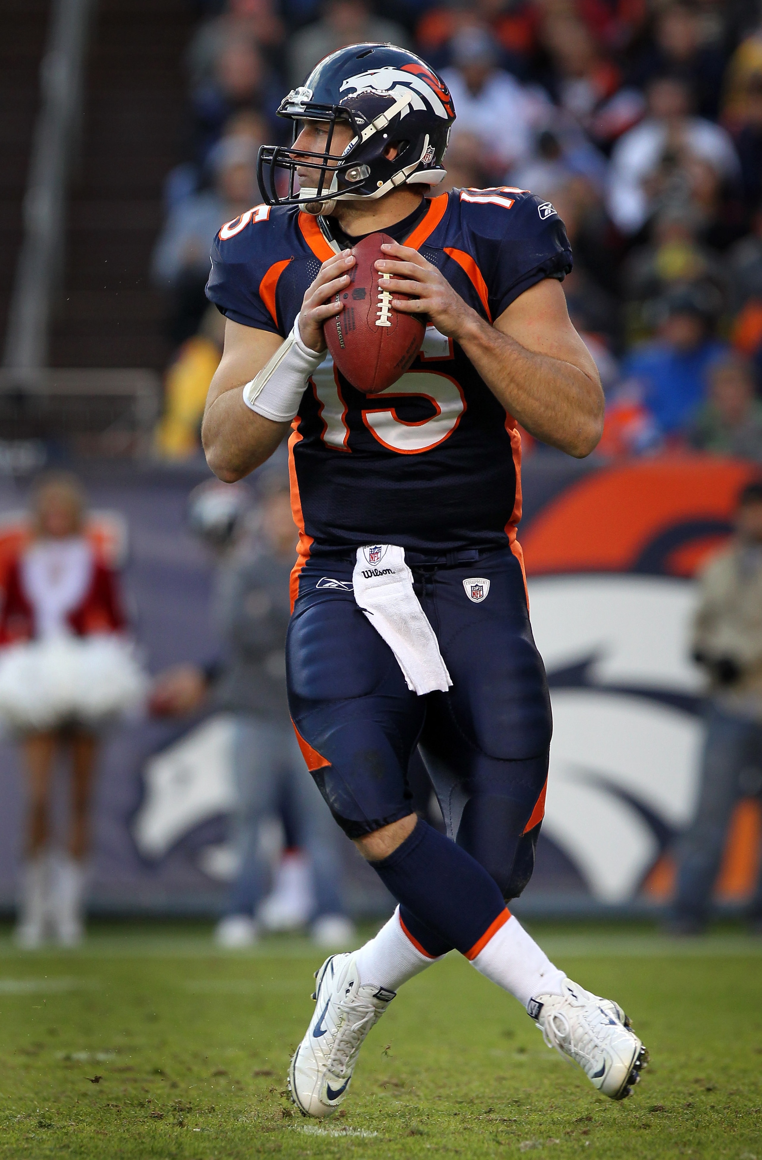 DENVER - DECEMBER 26: Quarterback Tim Tebow #15 of the Denver Broncos rolls out and looks to deliver a pass against the Houston Texas at INVESCO Field at Mile High on December 26, 2010 in Denver, Colorado. The Broncos defeated the Texans 24-23. (Photo b DENVER - DECEMBER 26: Quarterback Tim Tebow #15 of the Denver Broncos rolls out and looks to deliver a pass against the Houston Texas at INVESCO Field at Mile High on December 26, 2010 in Denver, Colorado. The Broncos defeated the Texans 24-23. (Photo b