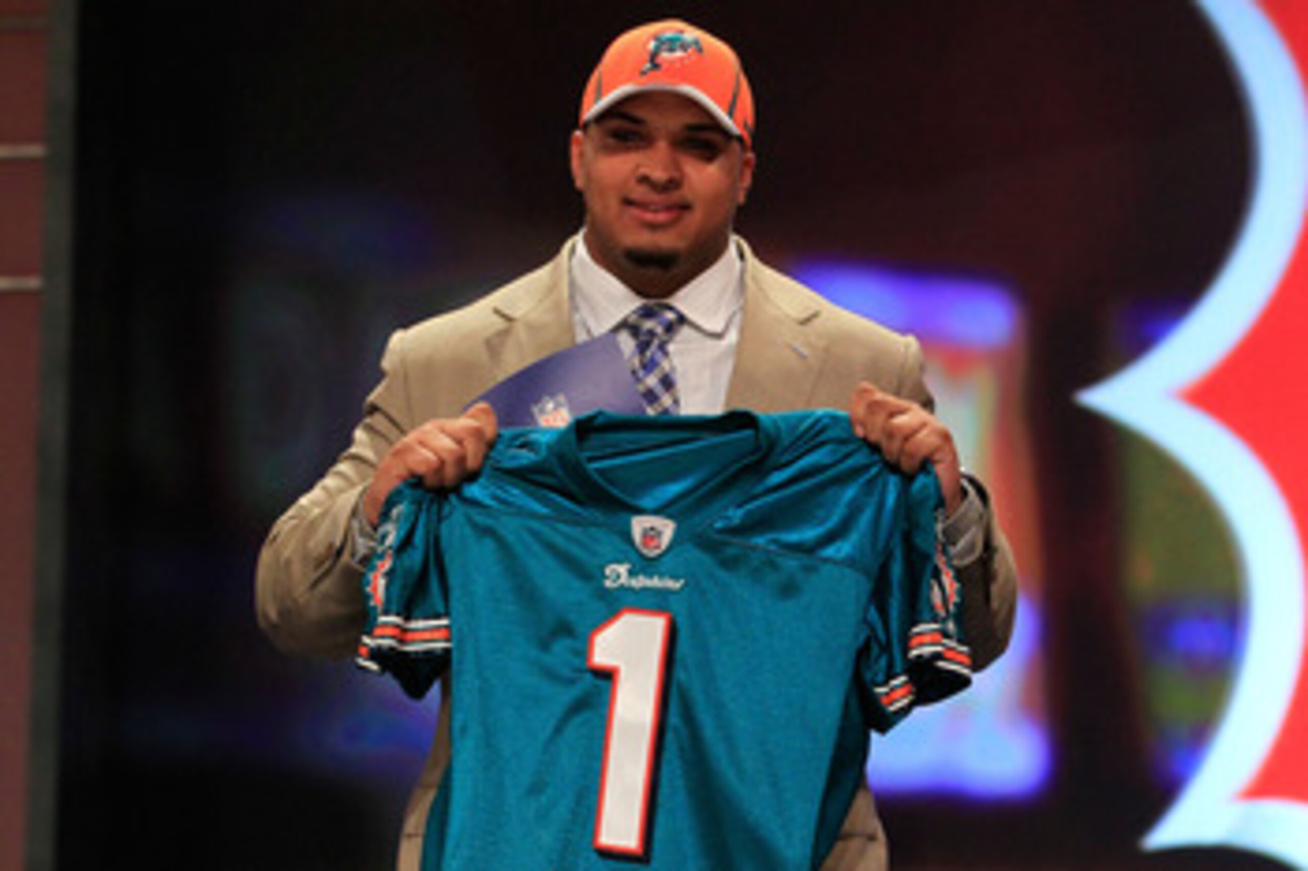 NEW YORK, NY - APRIL 28:  Mike Pouncey, #15 overall pick by the Miami Dolphins, holds up a jersey on stage during the 2011 NFL Draft at Radio City Music Hall on April 28, 2011 in New York City.  (Photo by Chris Trotman/Getty Images)
