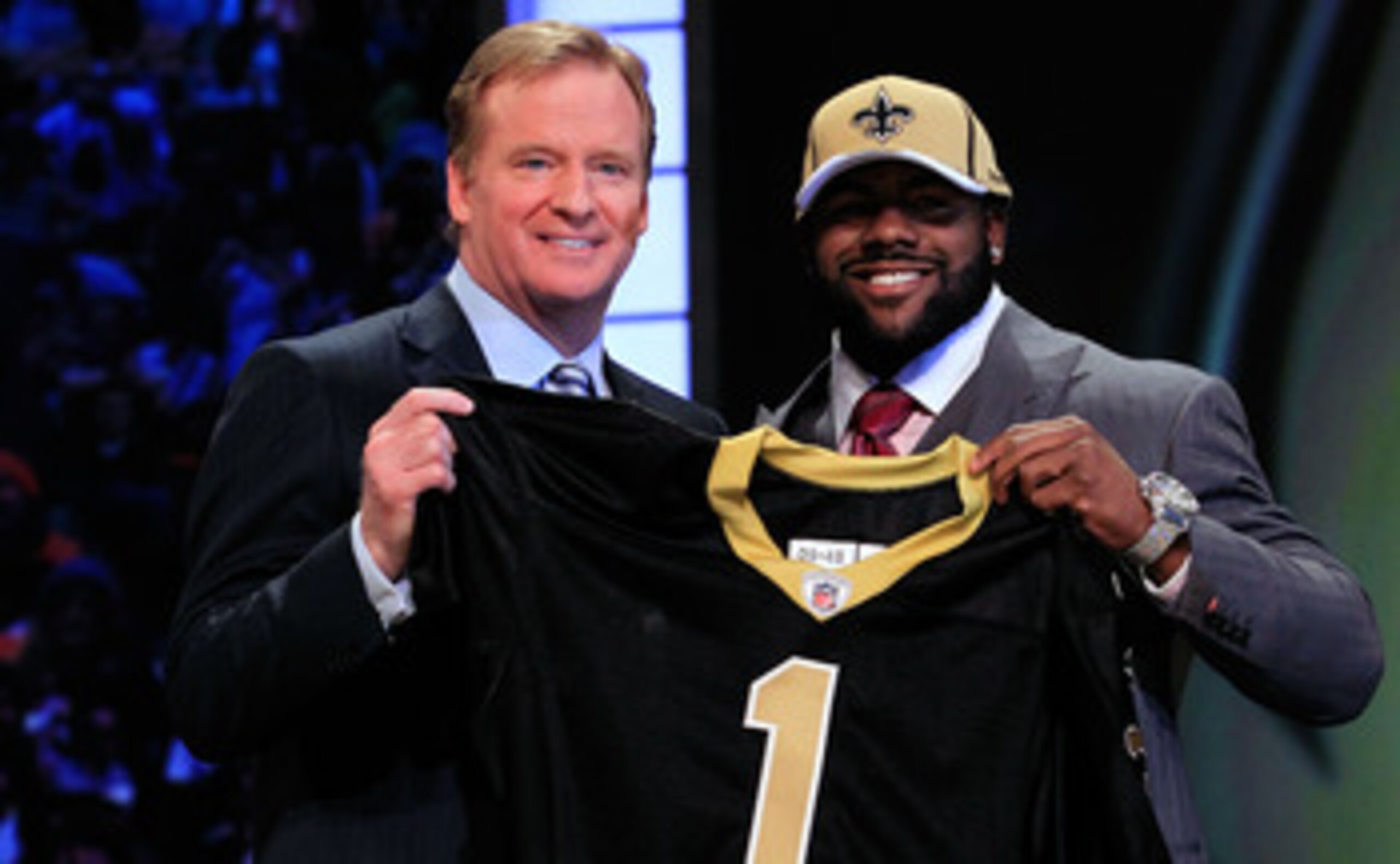 NEW YORK, NY - APRIL 28: NFL Commissioner Roger Goodell (L) poses for a photo with Mark Ingram, #28 overall pick by the New Orleans Saints, holds up a jersey on stage during the 2011 NFL Draft at Radio City Music Hall on April 28, 2011 in New York City. NEW YORK, NY - APRIL 28: NFL Commissioner Roger Goodell (L) poses for a photo with Mark Ingram, #28 overall pick by the New Orleans Saints, holds up a jersey on stage during the 2011 NFL Draft at Radio City Music Hall on April 28, 2011 in New York City.