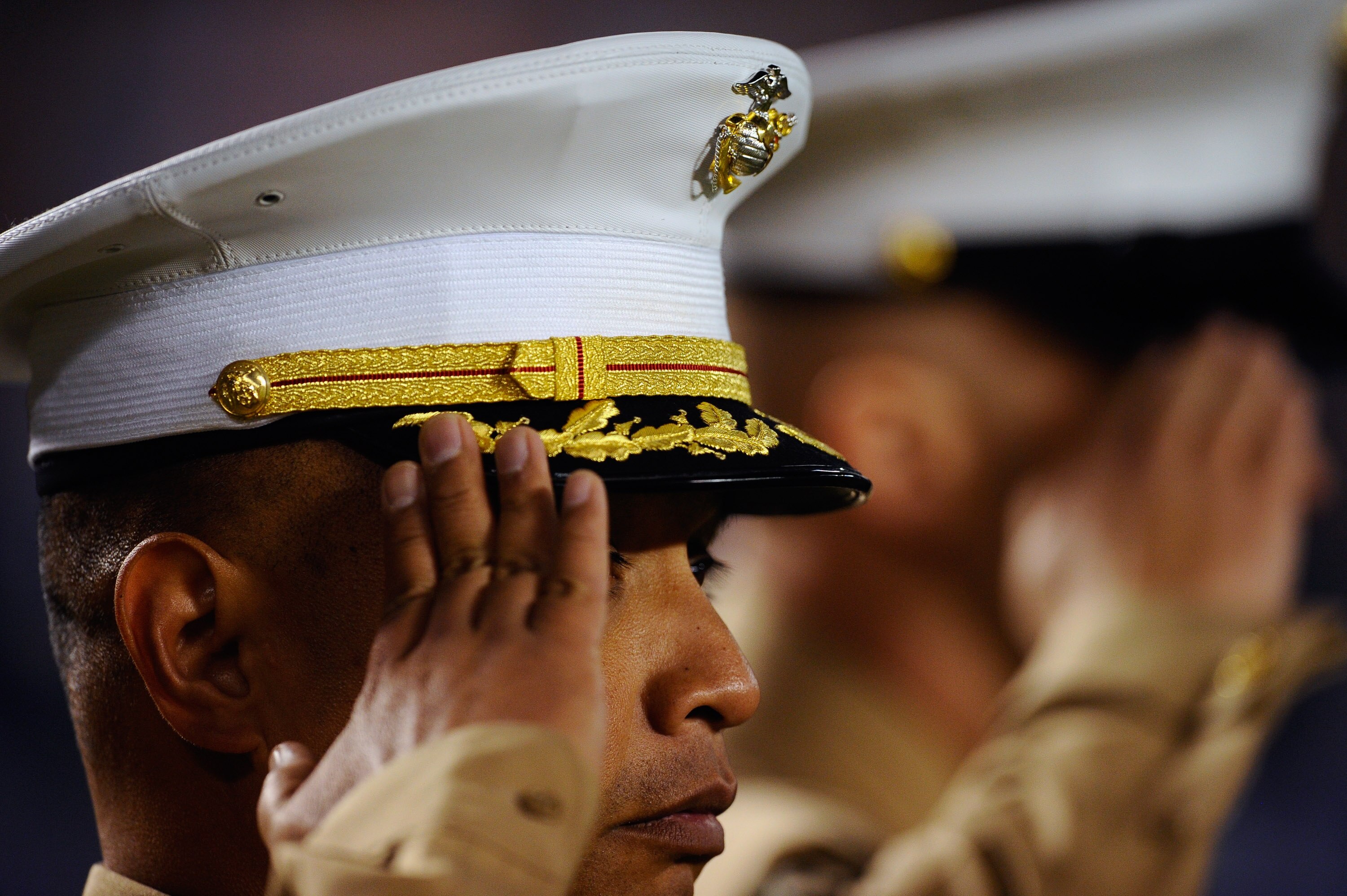 SAN DIEGO - NOVEMBER 22:  Members of US Marines salute prior to the start of the football game between the Denver Broncos and San Diego Chargers at Qualcomm Stadium on November 22, 2010 in San Diego, California.  (Photo by Kevork Djansezian/Getty Images)