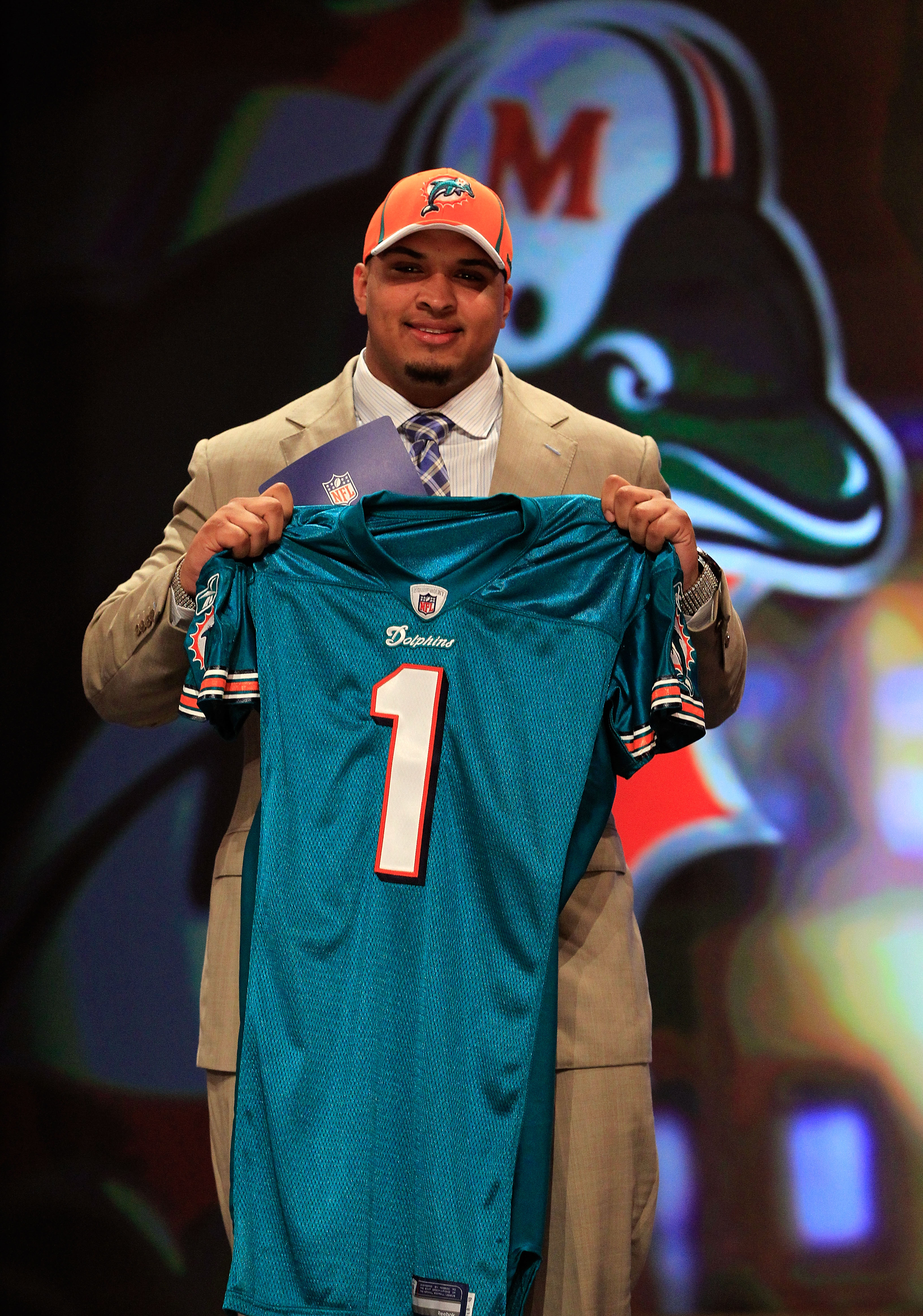 NEW YORK, NY - APRIL 28:  Mike Pouncey, #15 overall pick by the Miami Dolphins, holds up a jersey on stage during the 2011 NFL Draft at Radio City Music Hall on April 28, 2011 in New York City.  (Photo by Chris Trotman/Getty Images)