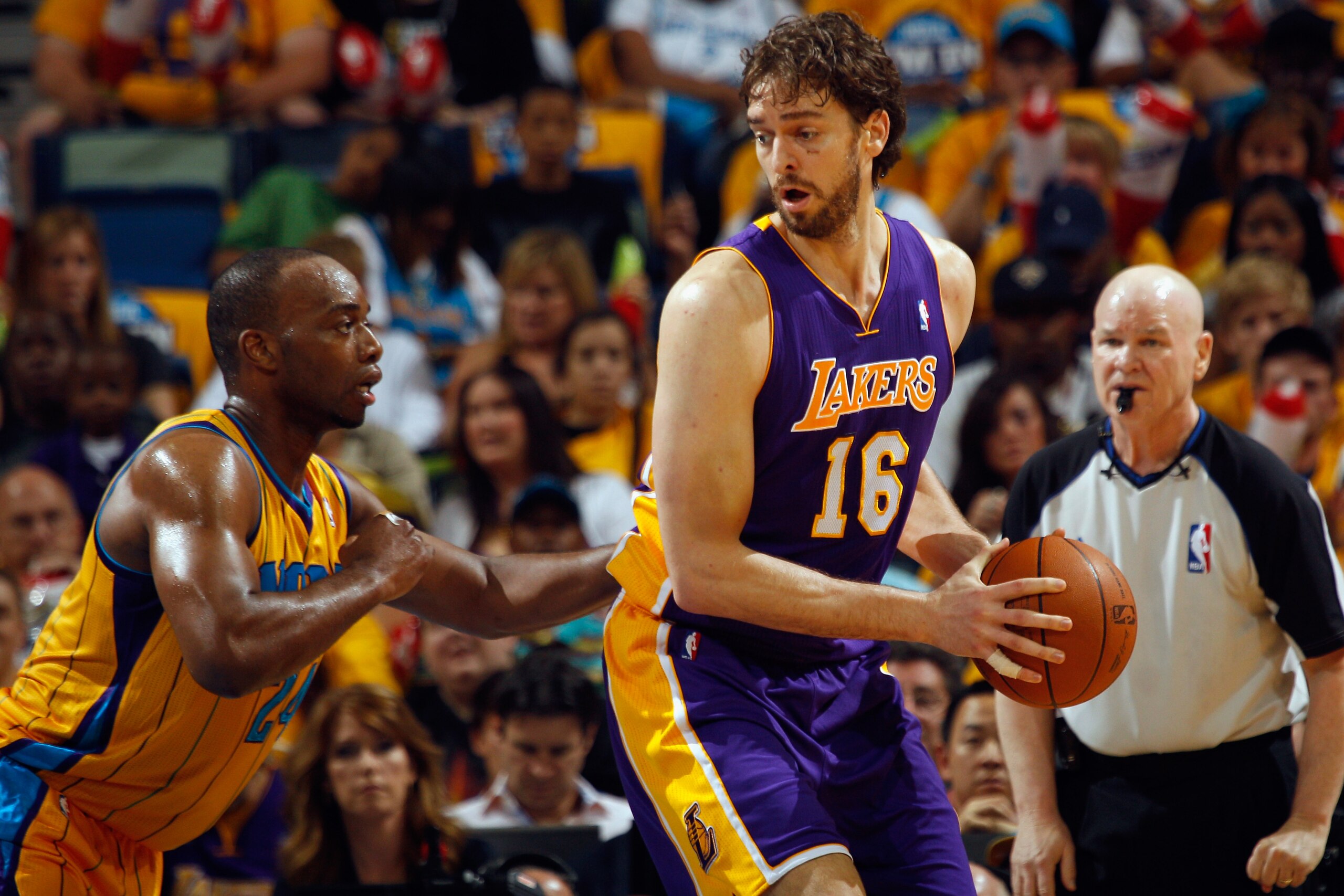 NEW ORLEANS, LA - APRIL 22:  Pau Gasol #16 of the Los Angeles Lakers drives the ball around Carl Landry #24 of the New Orleans Hornets in Game Three of the Western Conference Quarterfinals in the 2011 NBA Playoffs at the New Orleans Arena  on April 22, 20