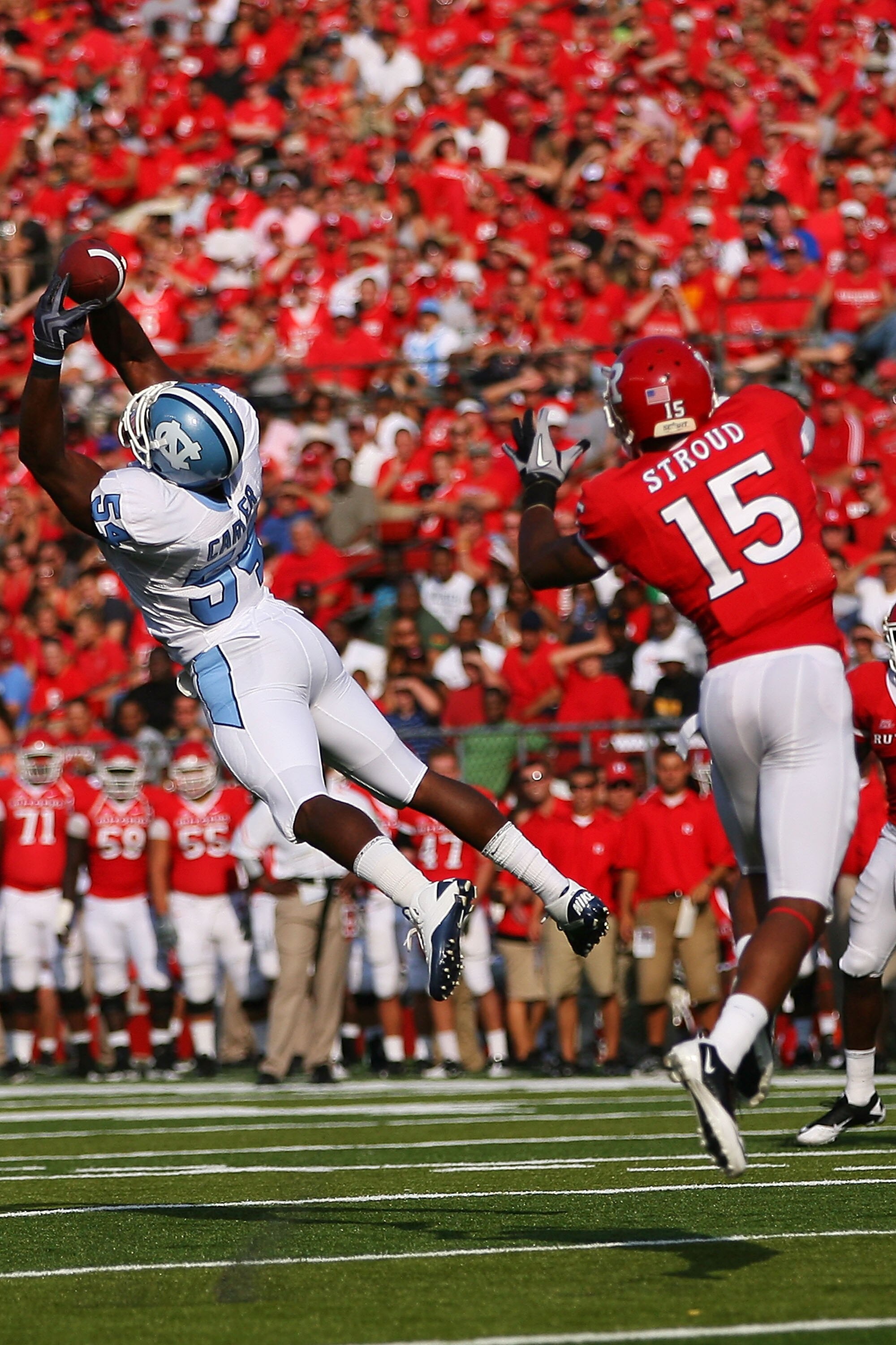 NEW BRUNSWICK, NJ - SEPTEMBER 25: Bruce Carter #54 of the North Carolina Tar Heels intercepts a pass intented for Keith Stroud #15 of the Rutgers Scarlet Knights during the second quarter at Rutgers Stadium on September 25, 2010 in New Brunswick, New Jers
