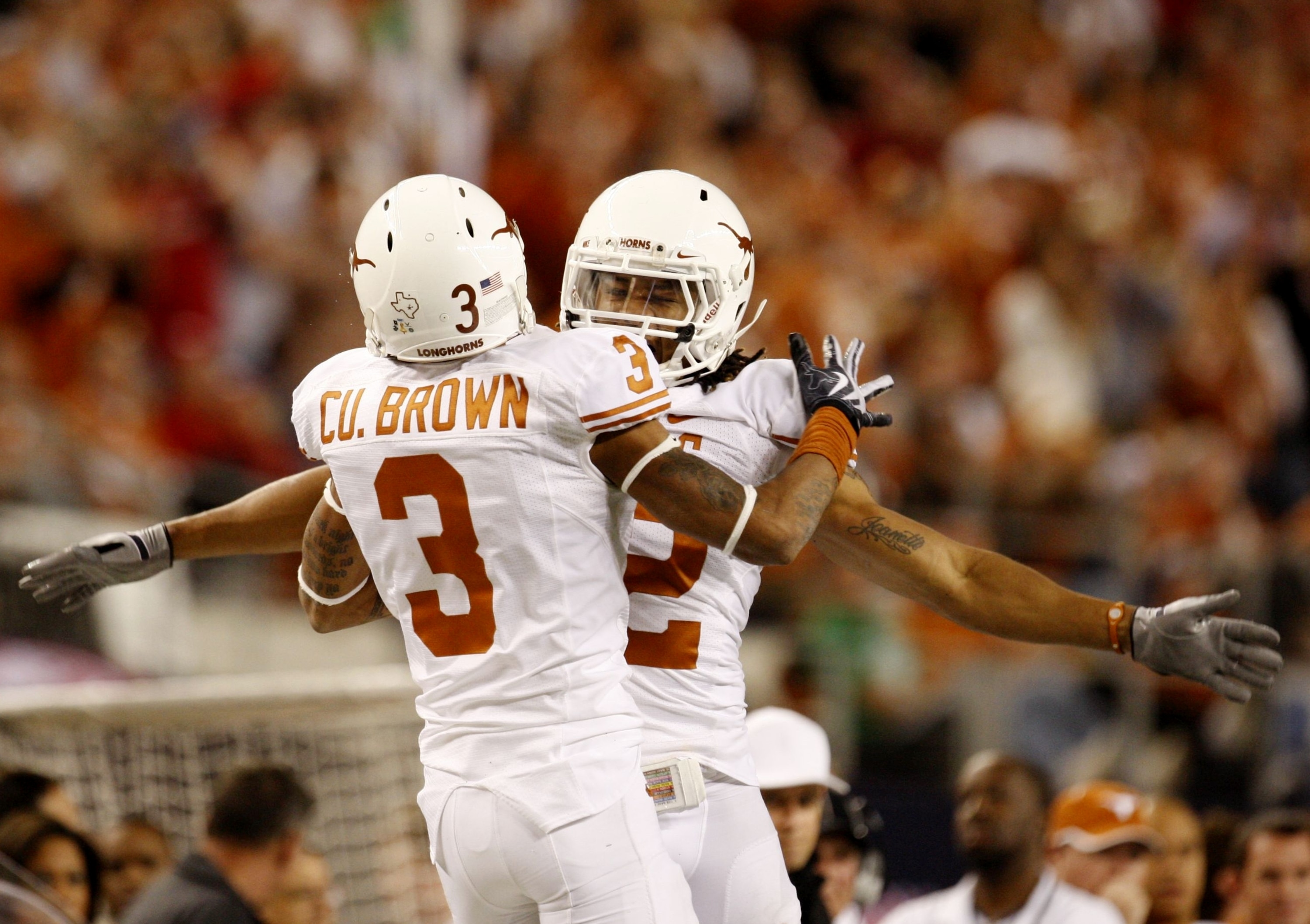 ARLINGTON, TX - DECEMBER 5:  Curtis Brown #3 and Earl Thomas #12 of the Texas Longhorns celebrate breaking up a pass against the Nebraska Cornhuskers in the third quarter at Cowboys Stadium on December 5, 2009 in Arlington, Texas.  (Photo by Ronald Martin
