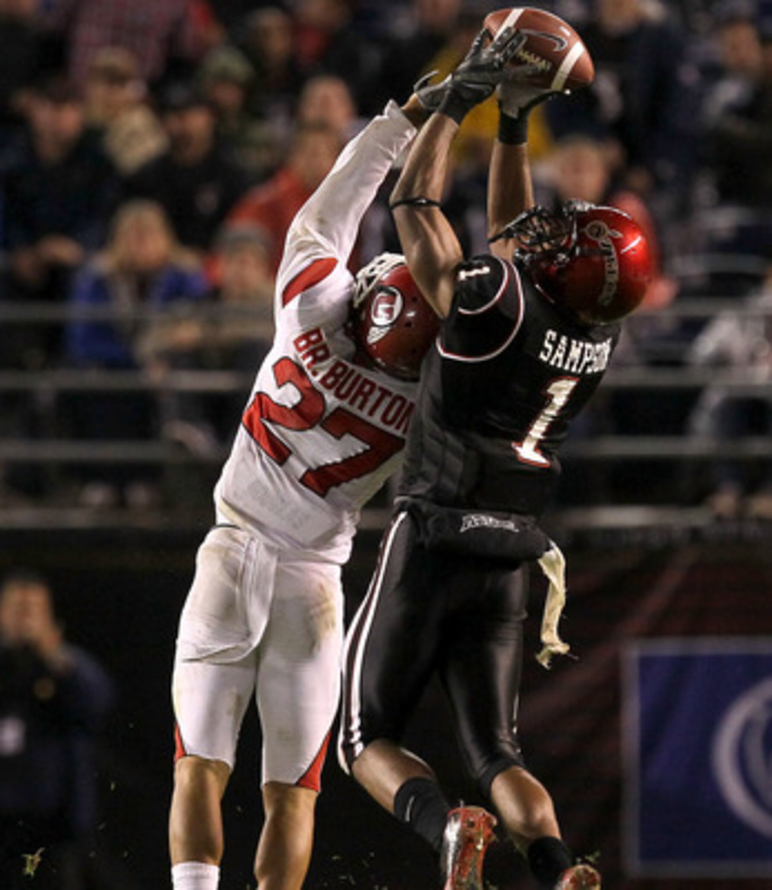 SAN DIEGO - NOVEMBER 20:  Wide receiver DeMarco Sampson #1 of the San Diego State Aztecs makes a catch over cornerback Brandon Burton #27 of the Utah Utes at Qualcomm Stadium on November 20, 2010 in San Diego, California.  Utah won 38-34.  (Photo by Steph