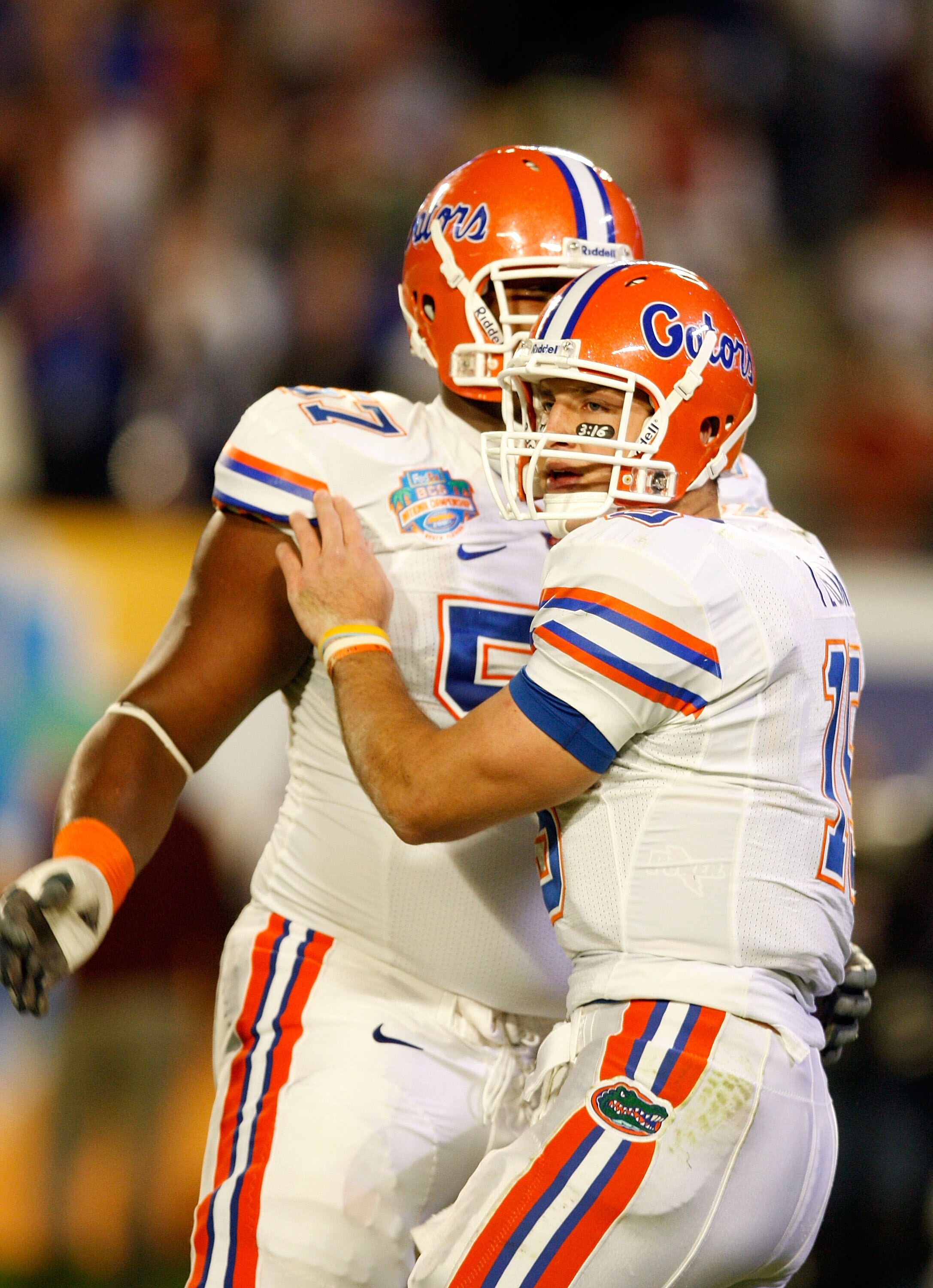 MIAMI - JANUARY 08:  Tim Tebow #15 (R) and Carl Johnson #57 of the Florida Gators celebrate after Tebow threw a 20-yard touchdown pass to Louis Murphy #9 in the second quarter against the Oklahoma Sooners during the FedEx BCS National Championship game at