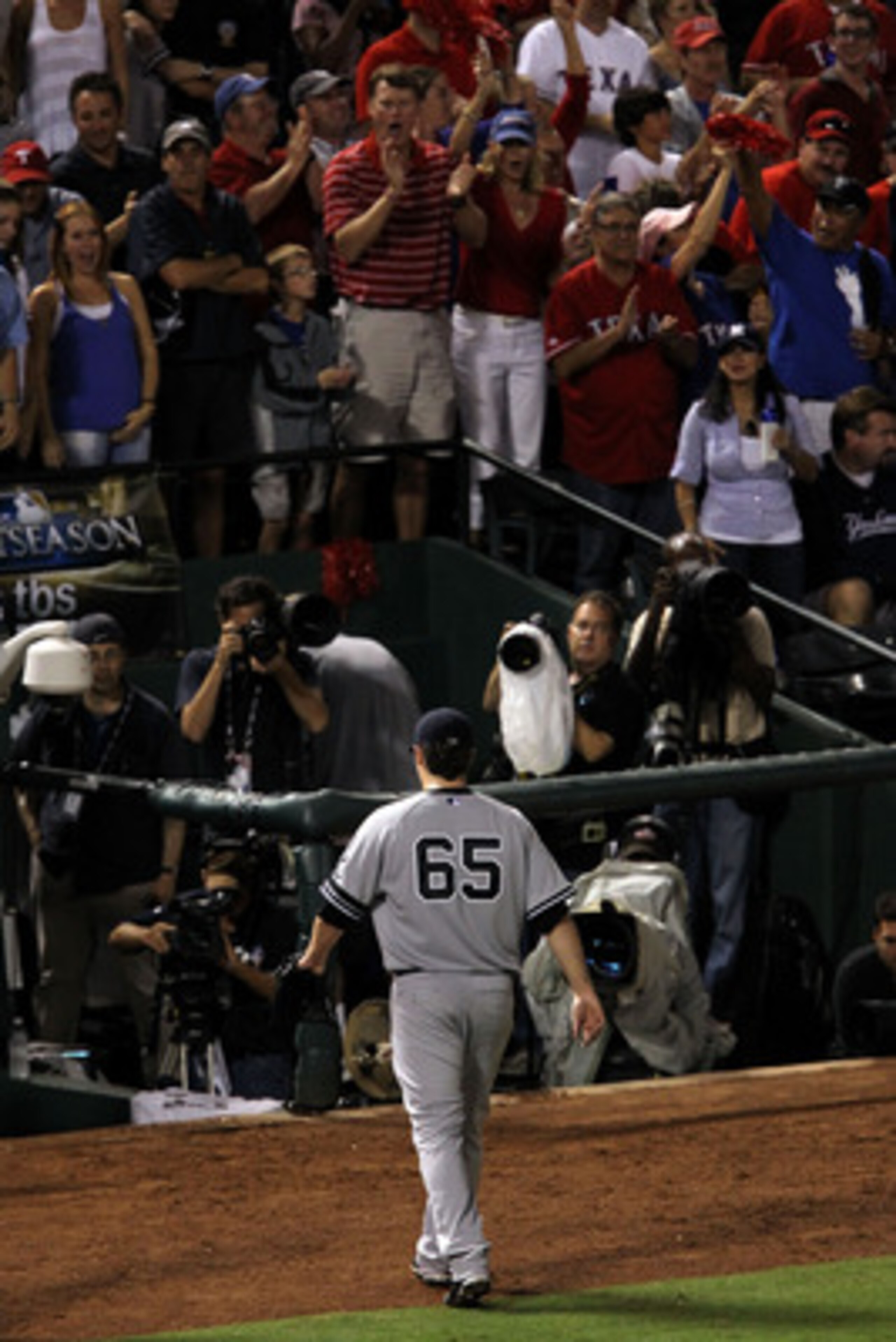 ARLINGTON, TX - OCTOBER 22:  Phil Hughes #65 of the New York Yankees walks off the field after being pulled in the fifth inning of Game Six of the ALCS against the Texas Rangers during the 2010 MLB Playoffs at Rangers Ballpark in Arlington on October 22, 