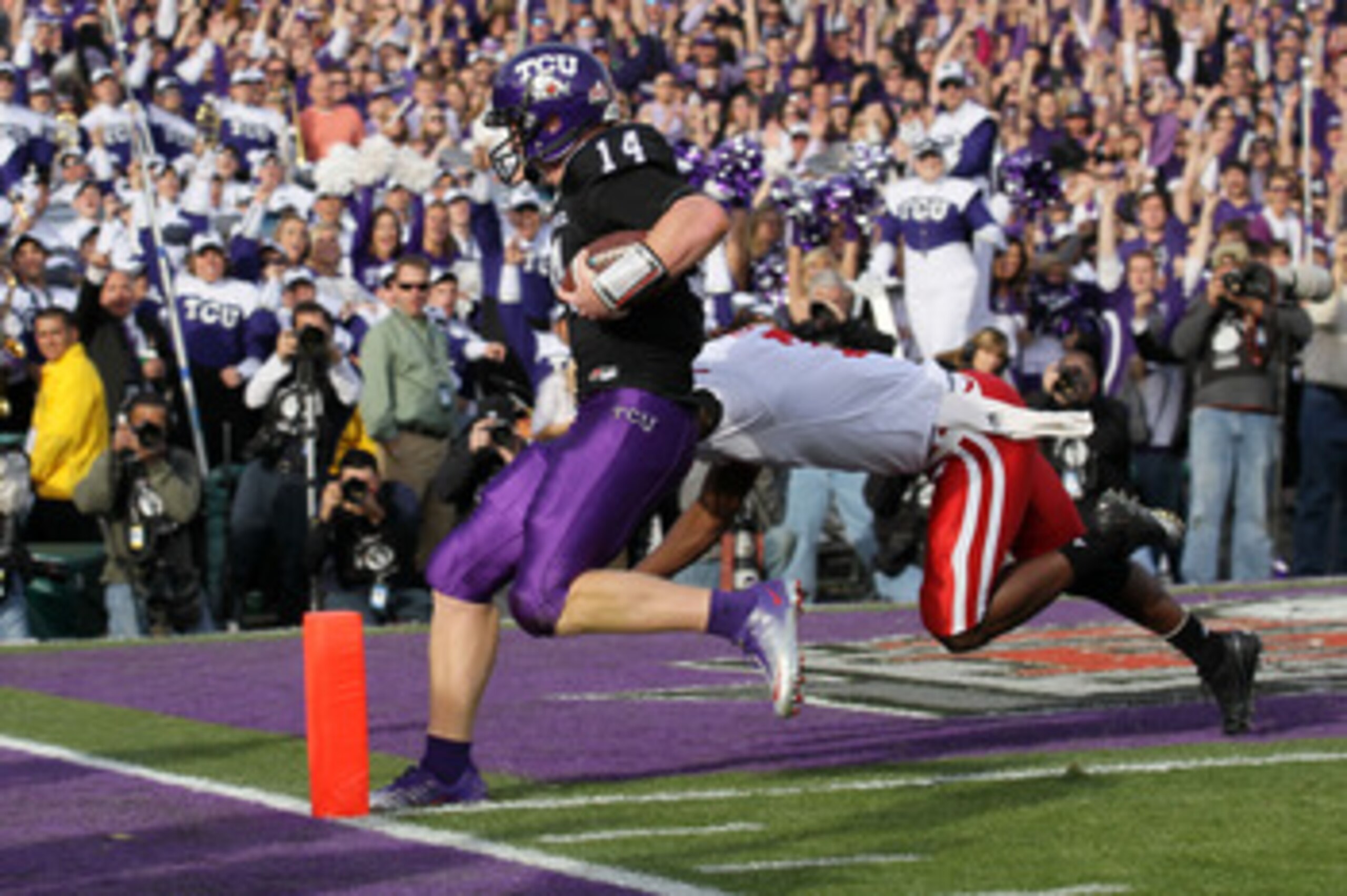 PASADENA, CA - JANUARY 01:  Quarterback Andy Dalton #14 of the TCU Horned Frogs scores a touchdown against the Wisconsin Badgers in the first quarter of the 97th Rose Bowl game on January 1, 2011 in Pasadena, California.  (Photo by Stephen Dunn/Getty Imag