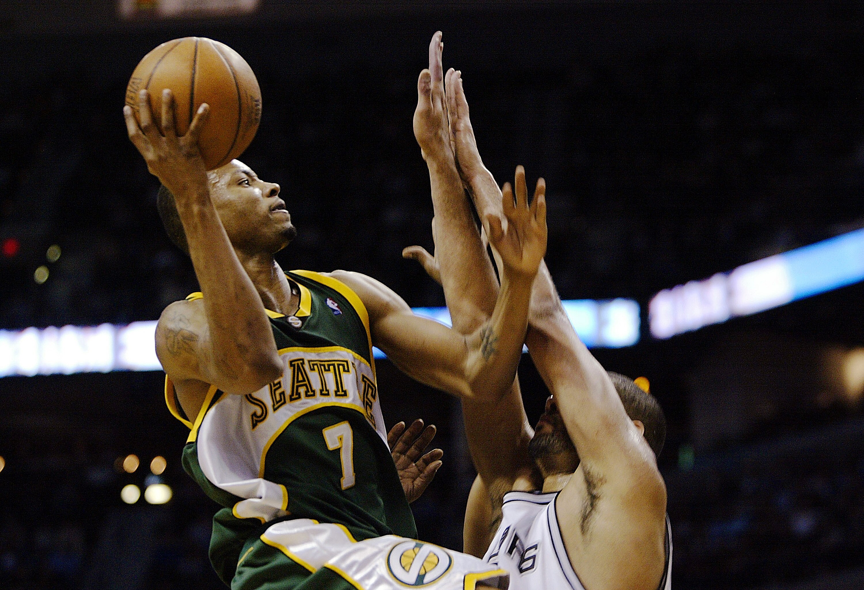 SAN ANTONIO - MAY 8:  Rashard Lewis #7 of the Seattle SuperSonics takes the ball up against Tim Duncan #21 of the San Antonio Spurs during the fourth quarter in Game one of the Western Conference Semifinals during the 2005 NBA Playoffs at the SBC Center o
