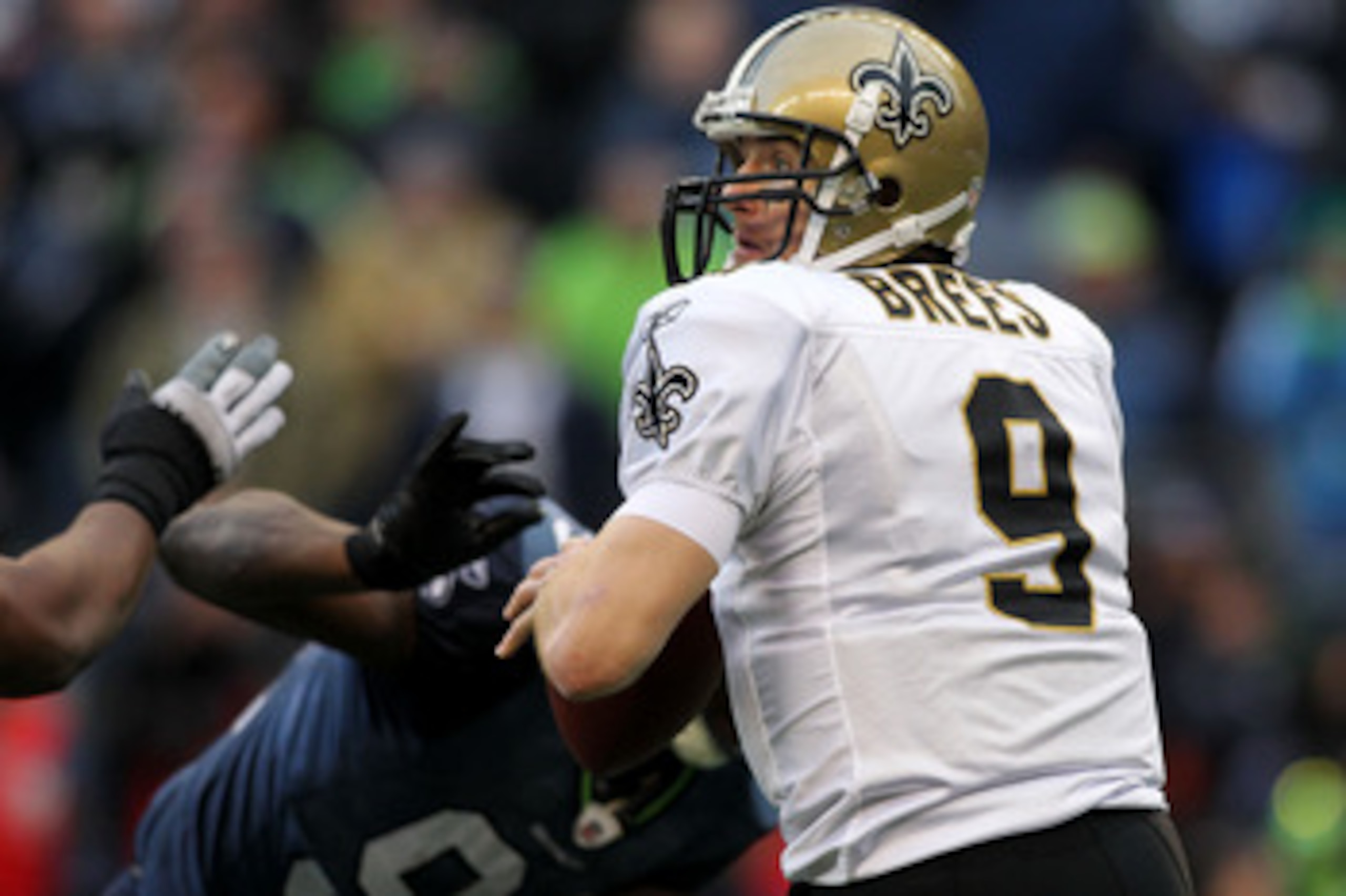 SEATTLE, WA - JANUARY 08:  Quarterback Drew Brees #9 of the New Orleans Saints scrambles against the Seattle Seahawks during the 2011 NFC wild-card playoff game at Qwest Field on January 8, 2011 in Seattle, Washington.  (Photo by Jonathan Ferrey/Getty Ima