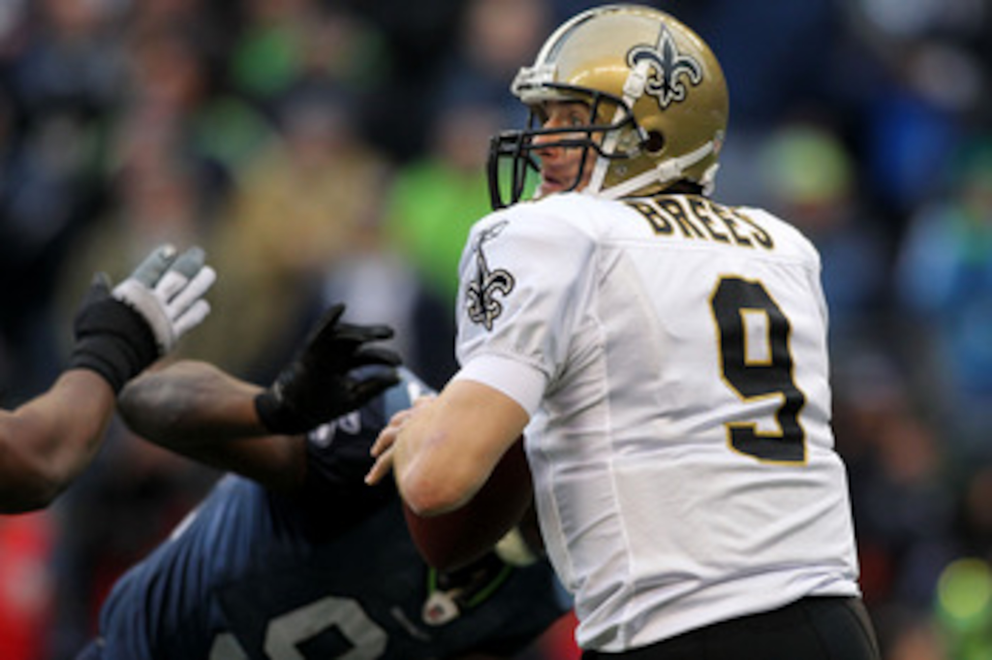 SEATTLE, WA - JANUARY 08:  Quarterback Drew Brees #9 of the New Orleans Saints scrambles against the Seattle Seahawks during the 2011 NFC wild-card playoff game at Qwest Field on January 8, 2011 in Seattle, Washington.  (Photo by Jonathan Ferrey/Getty Ima